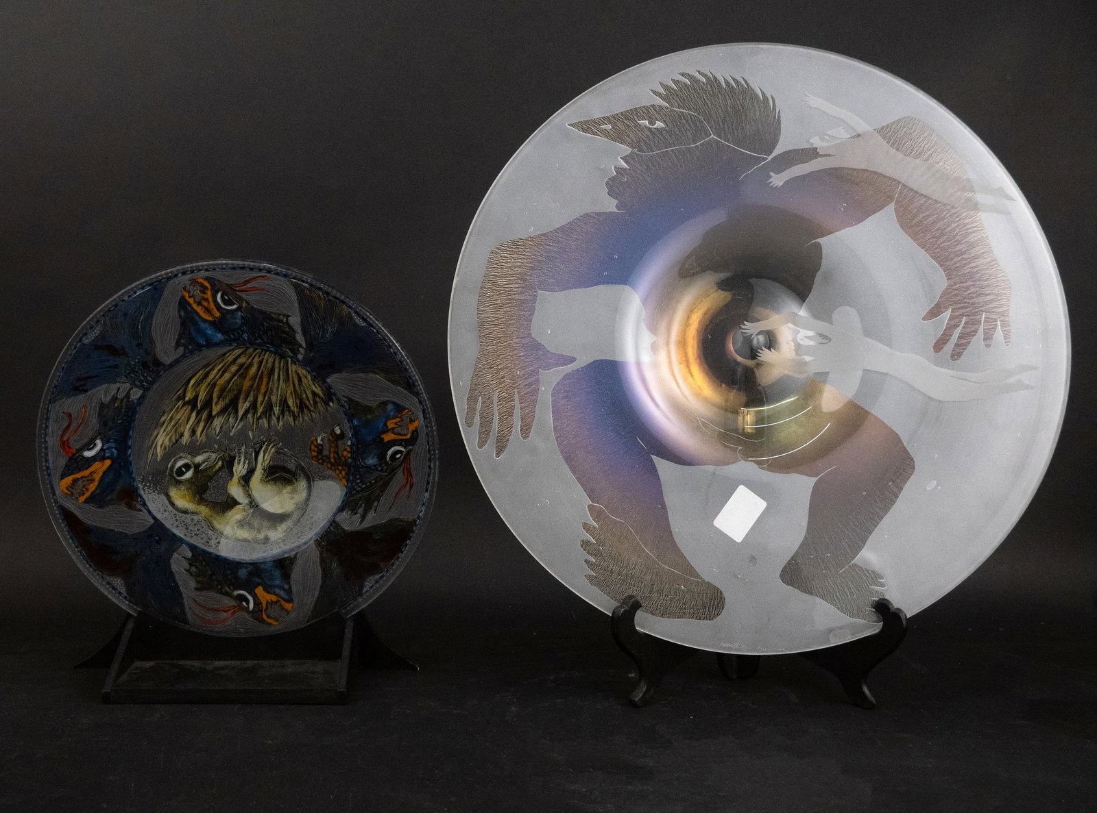 Deb Cocks "Claw" Reverse Painted Glass Charger: Deb Cocks "Claw" Reverse Painted Glass Charger On fitted wood base. Together with a Steven Newell "Three Masked Men" Charger, Clear and frosted blown and sandblasted glass. Provenance: Barry S.