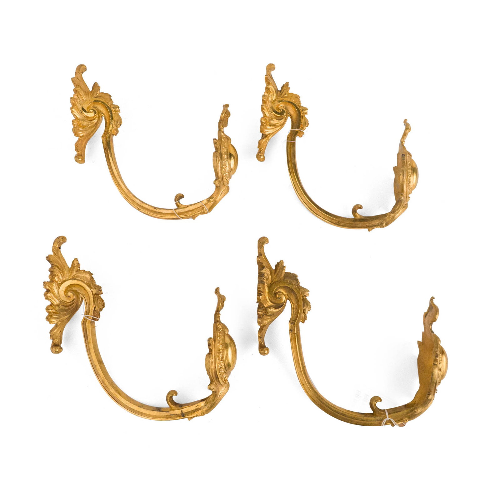 Set of Four Gilt Bronze Curtain Tie Backs: Set of Four Gilt Bronze Curtain Tie Backs Late 19th or early 20th century, The C-scroll arms with cartouche terminals issuing from foliate backplates Provenance: Christies London, Jun 7, 2000, lot