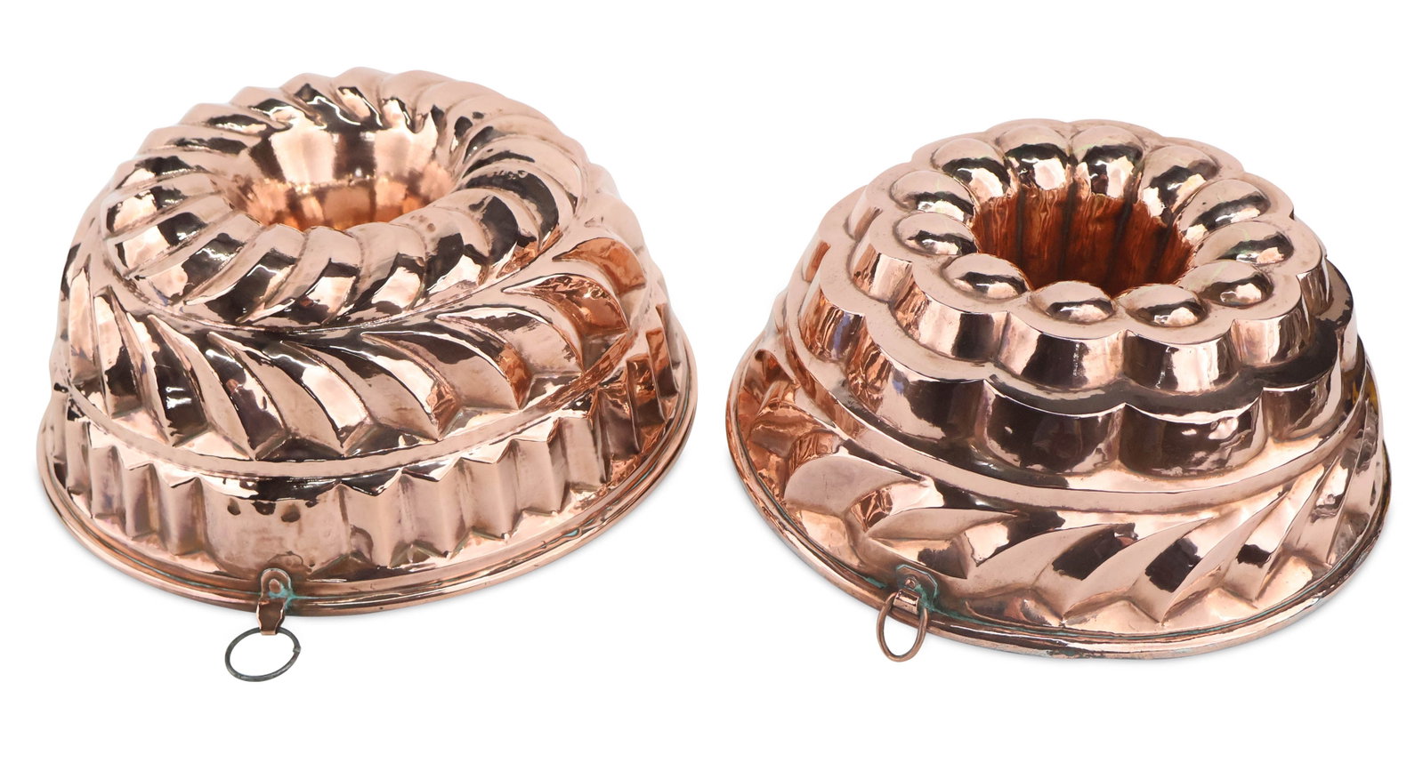 Two Large English Copper Molds/Bundt Pans: Two Large English Copper Molds/Bundt Pans Second-half 19th C. Provenance: Property from a Private Michigan Collection First 4 x 9 1/2 in. (10.2 x 24.1 cm.), Second 4 1/2 x 10 1/4 in. (11.4 x 26 cm.)