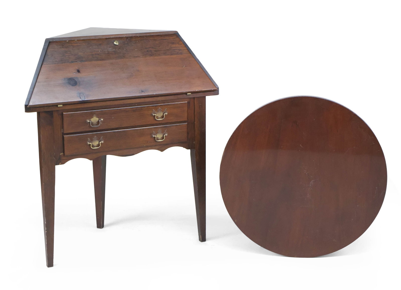 George III Style Mahogany Corner Desk: George III Style Mahogany Corner Desk 20th C. with two drawers under slant front top. Together with a mahogany lazy Susan. Lazy Susan needs to be oiled, surface distress, scratches, wear. Provenance: