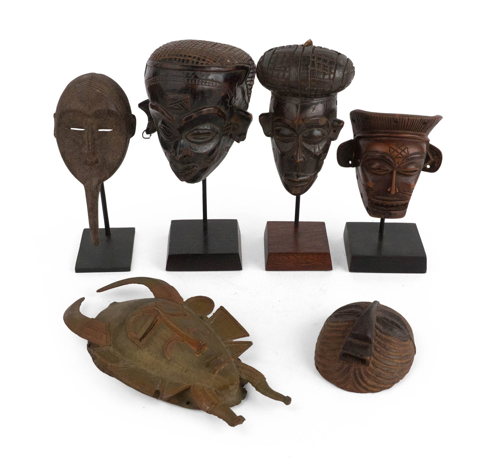 Six African Masks: Six African Masks Five carved wood and one mixed metal. All possibly reproductions. Largest: 10 x 5 1/2 in. (25.4 x 14 cm.)