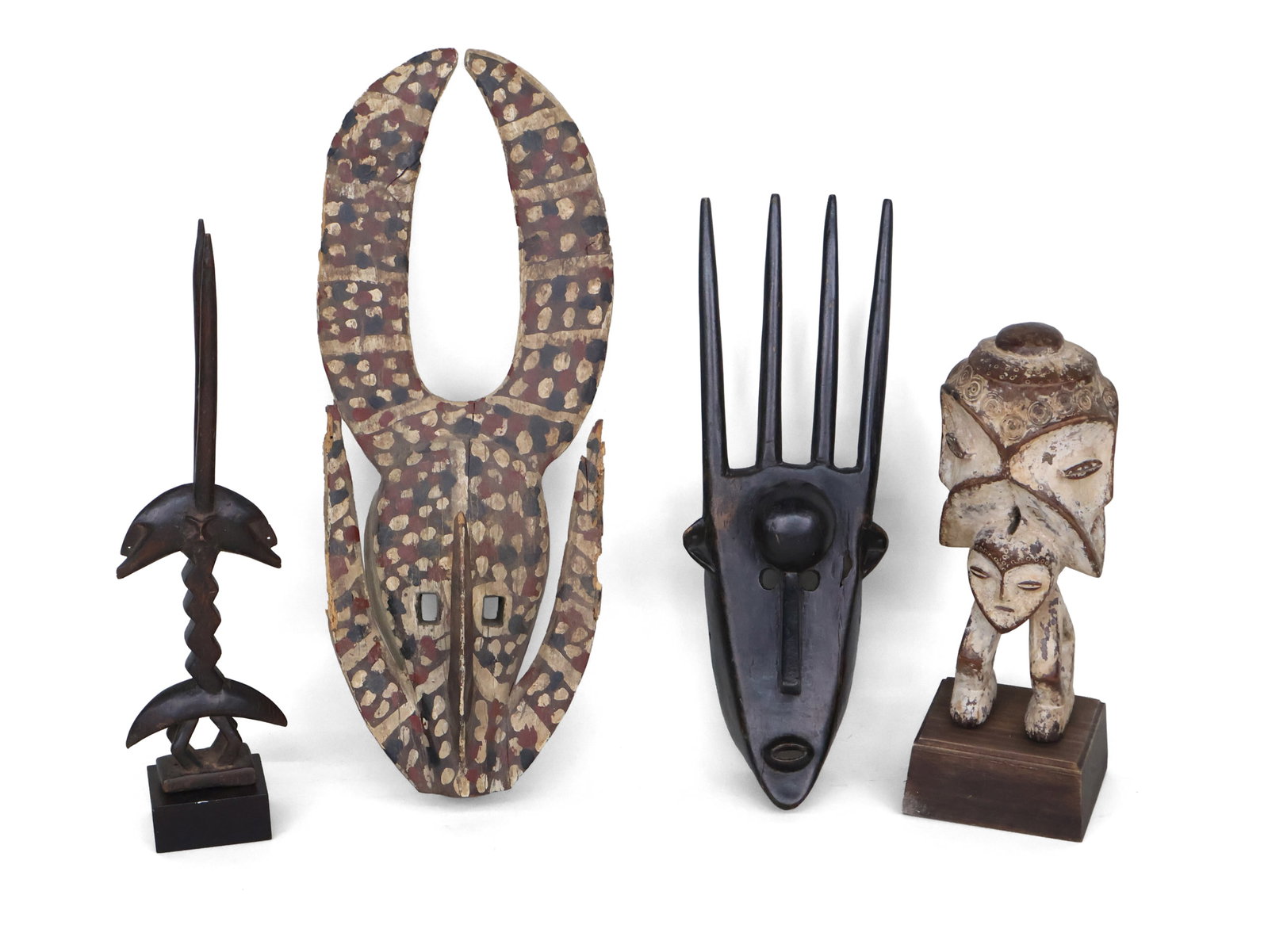 Bambara N'tomo Mask: Bambara N'tomo Mask From Mali. Together with an African carved and painted wood tribal mask, a Lega Sakimatwematew figure, and an African carved wood double sided figure. All possibly reproductions.
