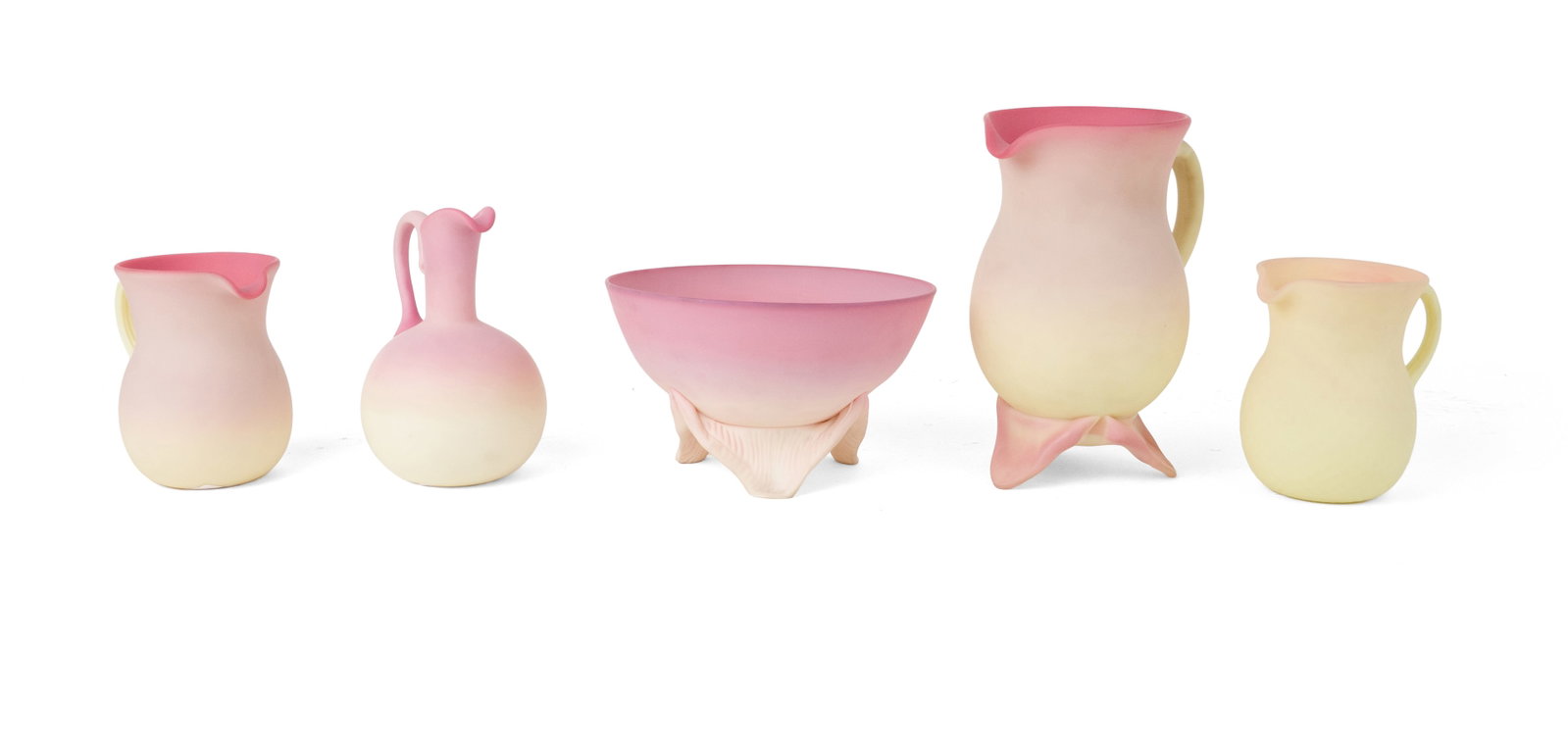 Five Gunderson Burmese Glass Table Articles: Five Gunderson Burmese Glass Table Articles 1952-1957, comprising, a footed bowl, a footed pitcher, two creamers, and a cruet. Provenance: Property Approved for Deaccession from a Distinguished New