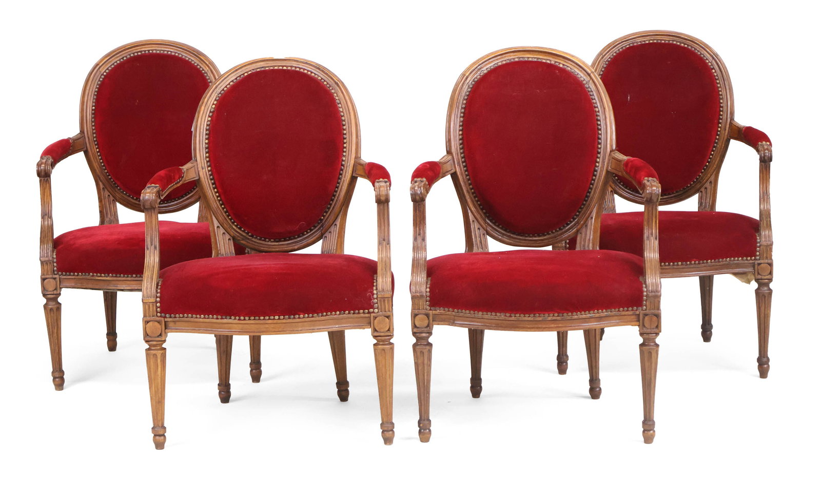 Four Louis XVI Carved Oak Fauteuils: Four Louis XVI Carved Oak Fauteuils French, c. 1780, with red velvet upholstery. 35 x 23 x 20 in. (88.9 x 58.4 x 50.8 cm.)
