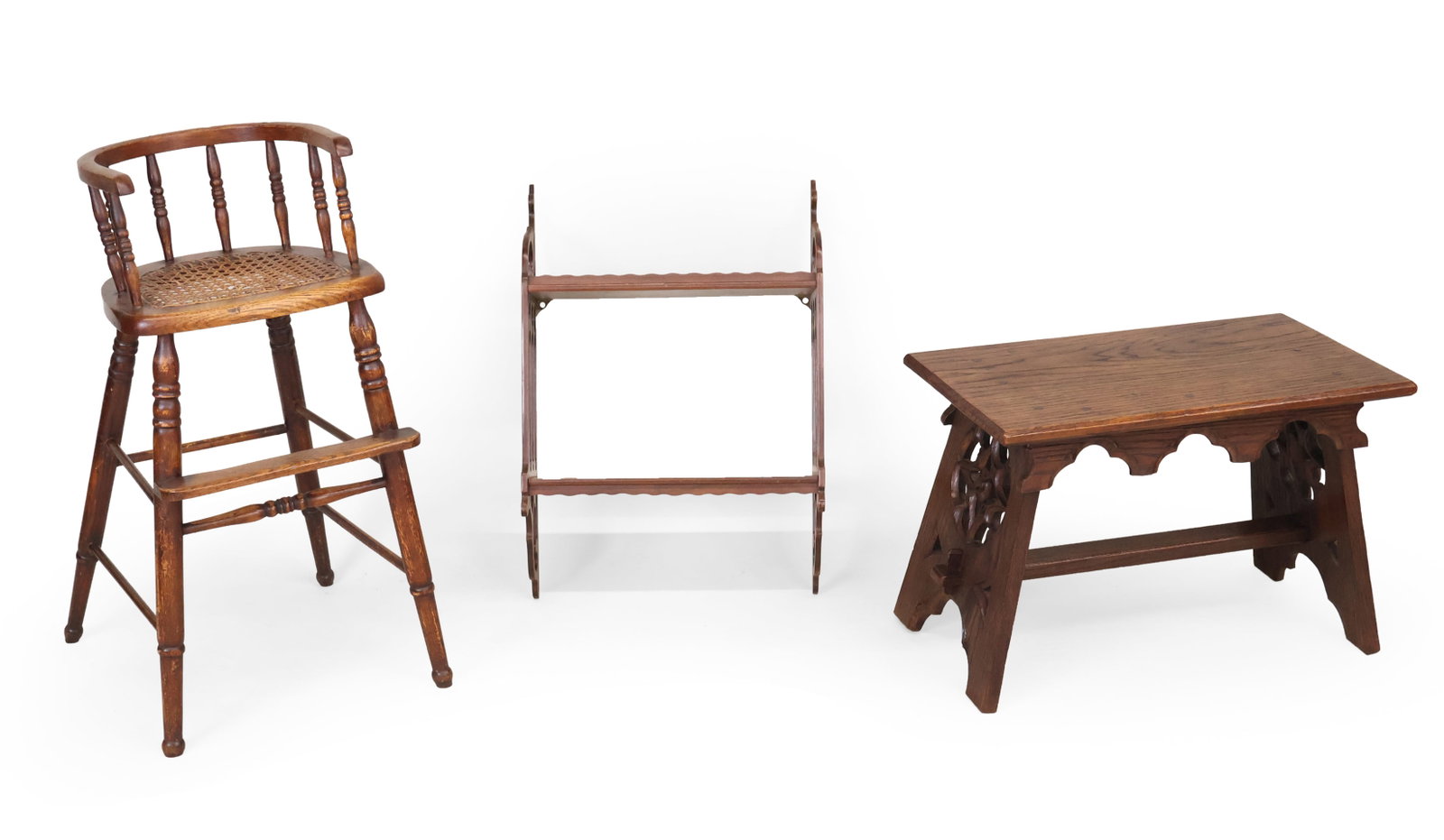 Gothic Oak Stool, Child's Chair, and Mahogany Shelf: Gothic Oak Stool, Child's Chair, and Mahogany Shelf English, 20th C. Comprising, a caned seat oak high chair and a pierced Gothic-style hanging book shelf. 3 pieces. Provenance: Property from a