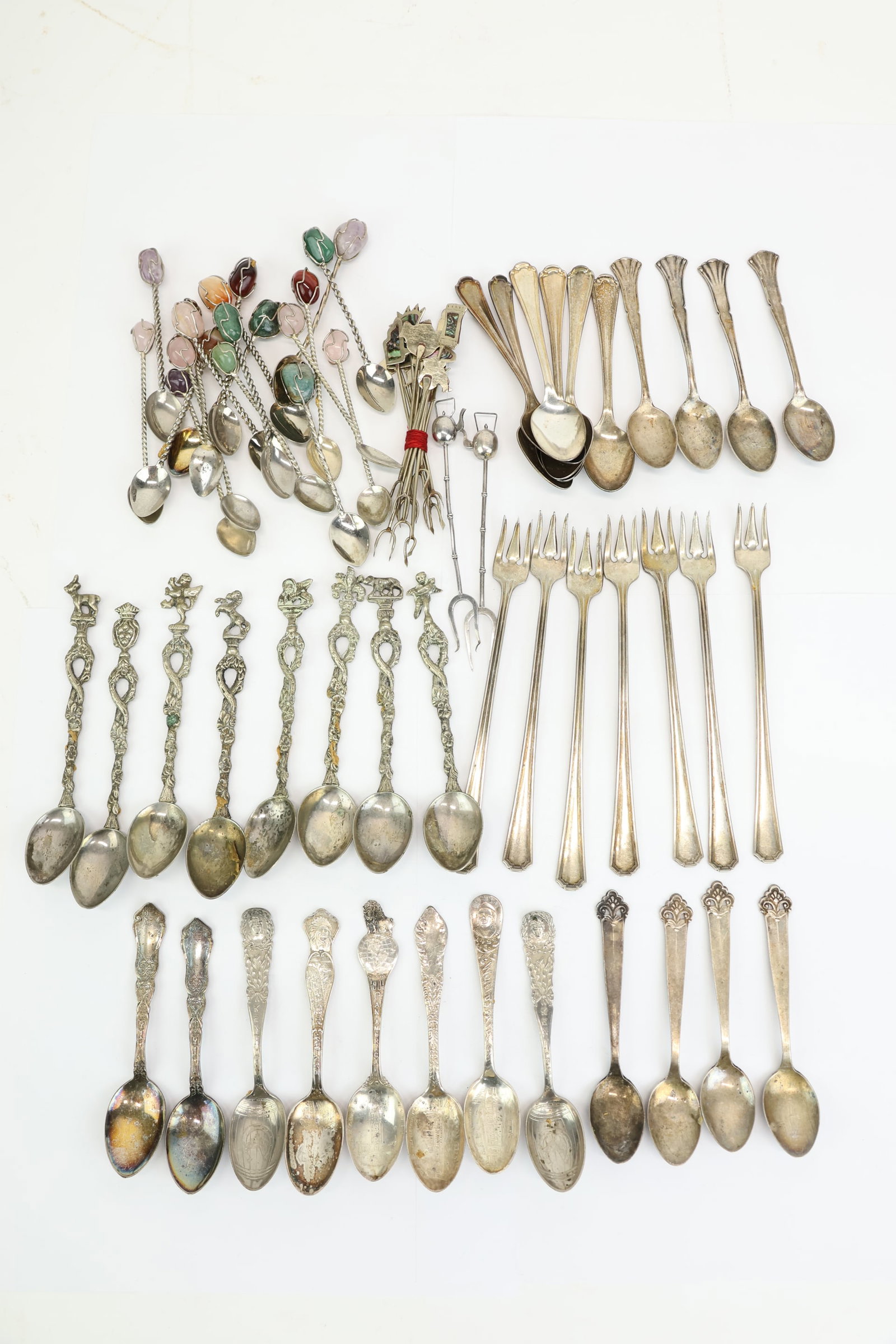 Group of Assorted Silver Plated Demi Tasse Spoons: Group of Assorted Silver Plated Demi Tasse Spoons Group of Assorted Silver Plated Demi Tasse Spoons. Together with a set of hardstone demi tasse spoons, cocktail forks, souvenir spoons including one f
