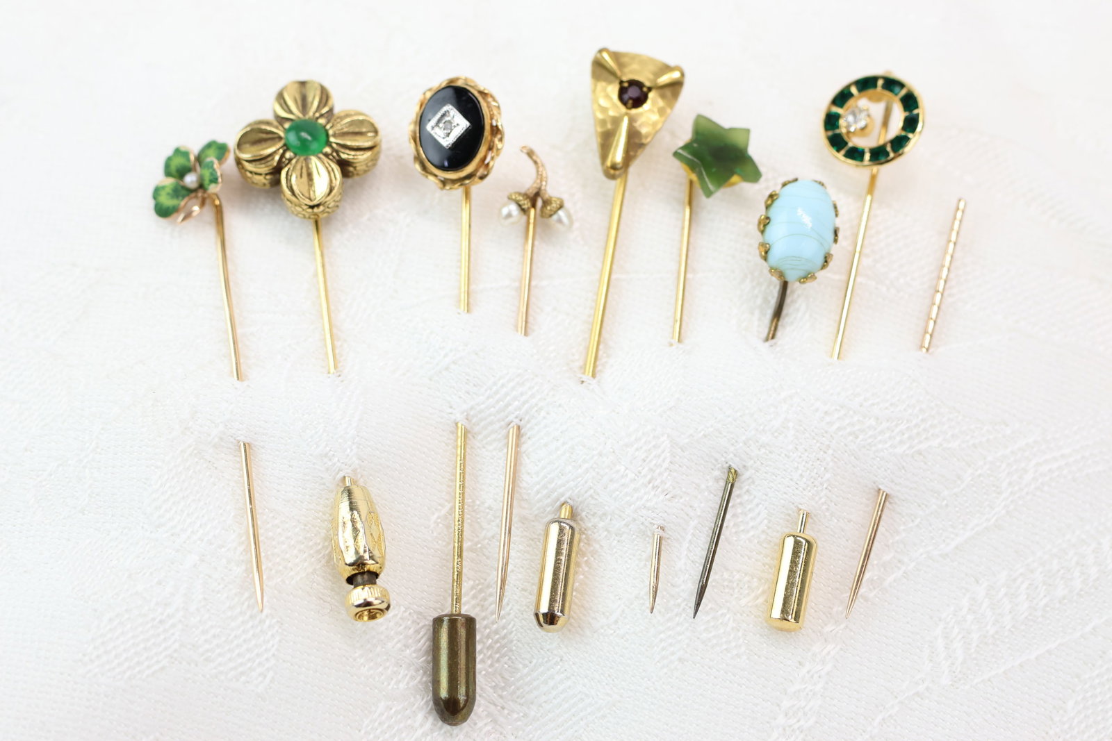 Vintage Group of Eight Assorted Stick Pins: Vintage Group of Eight Assorted Stick Pins Vintage Group of Eight Assorted Stick Pins. Including one 14k gold enameled shamrock, hammered pin with central ruby color, green cabochon inset stone