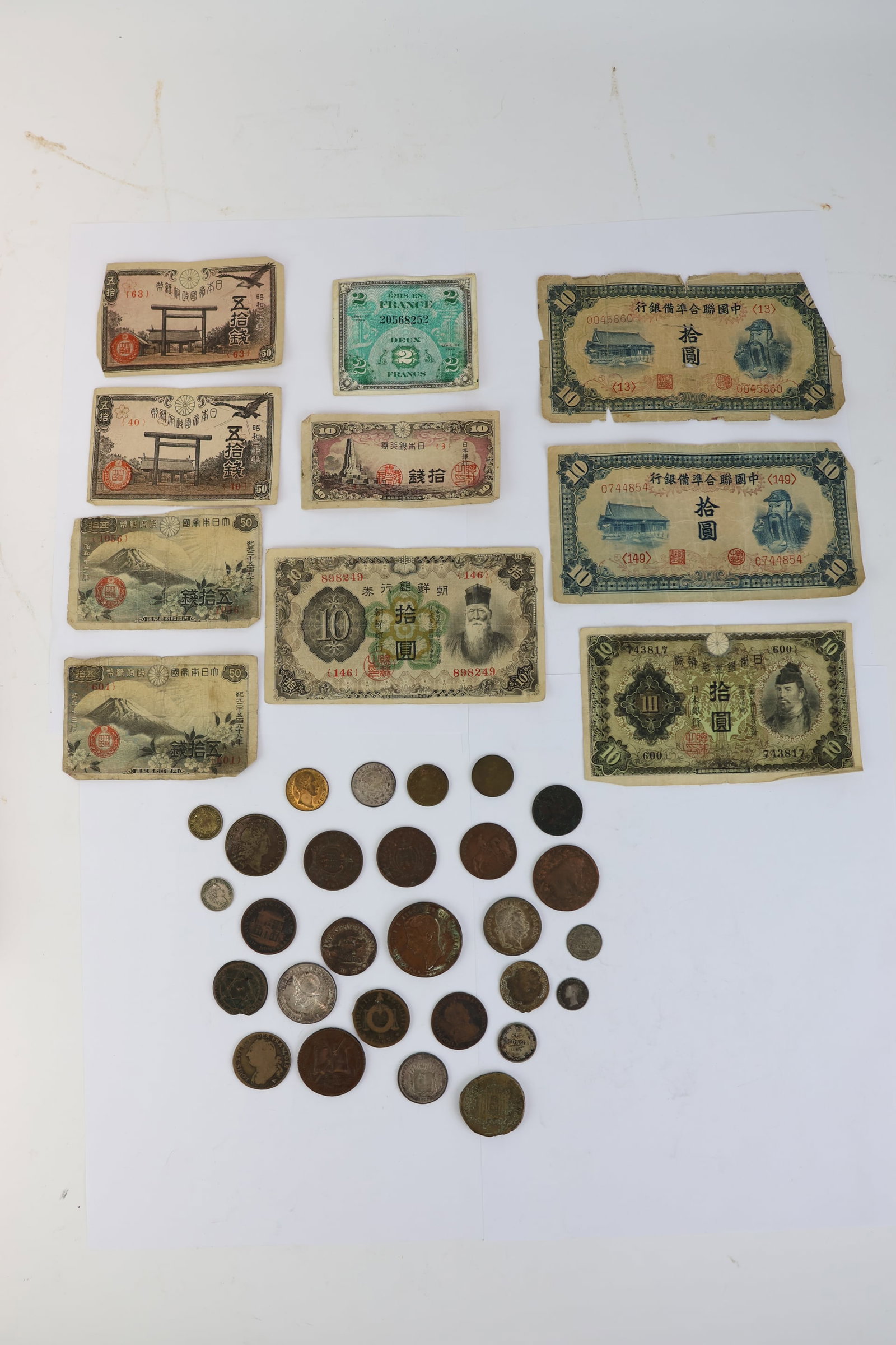 Group of Assorted Foreign Coins and Paper Money: Group of Assorted Foreign Coins and Paper Money Group of Assorted Foreign Coins and Paper Money. Including 1940's Asian bills, Marcus Agrippa coin, Louis XVI 1792 coin, 1859 copper 10 Tornesi coin,