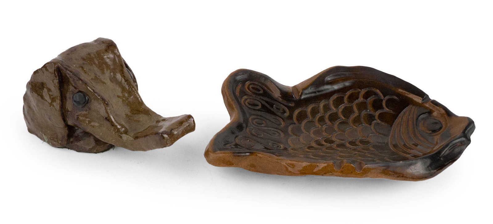 Art Pottery Fish-Form Bowl: Art Pottery Fish-Form Bowl Together with a glazed earthenware animal head, possibly an elephant. Chips. 3 x 15 x 10 in. (7.6 x 38.1 x 25.4 cm.), and 5 1/2 x 10 1/2 x 5 1/2 in. (14 x 26.7 x 14 cm.)