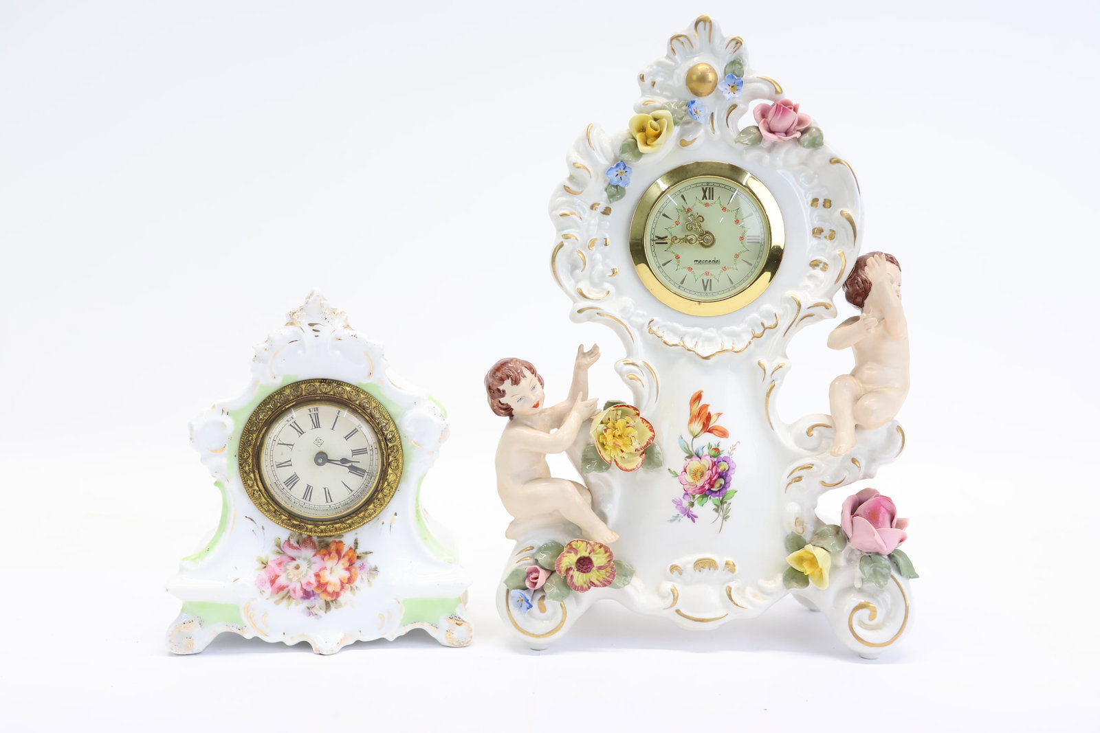 Two Porcelain Floral Decorated Mantel Clocks: Two Porcelain Floral Decorated Mantel Clocks Two Porcelain Floral Decorated Mantel Clocks, one marked by A.J. Uffrecht & Co., Bavaria, the smaller one by Ansonia. Used condition, wear, worn. 6 1/4"h