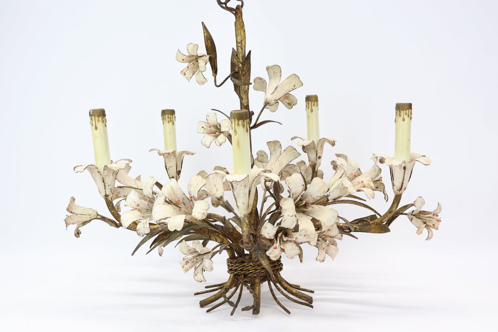 Vintage Toleware Chandelier: Vintage Toleware Chandelier Vintage Toleware Chandelier. Lighting fixture has 5 lights with candle style covers surrounded by a bouquet of white painted lilies. Used condition, wear, worn, unknown wor