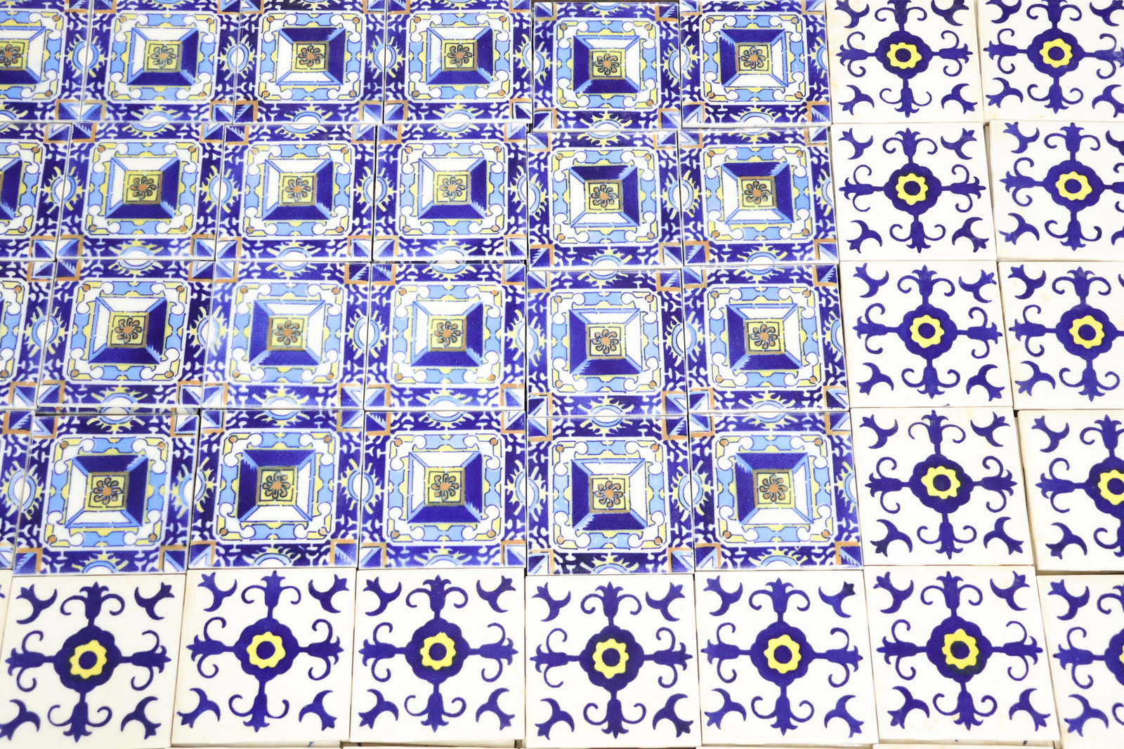 Group of 188 Glazed Ceramic Tiles: Group of 188 Glazed Ceramic Tiles Group of 188 Glazed Ceramic Tiles, made in Mexico, 92 of the blue and white and 96 of the blue, yellow, and white. Used condition, wear, worn. 4 3/8"h x 4 3/8"w