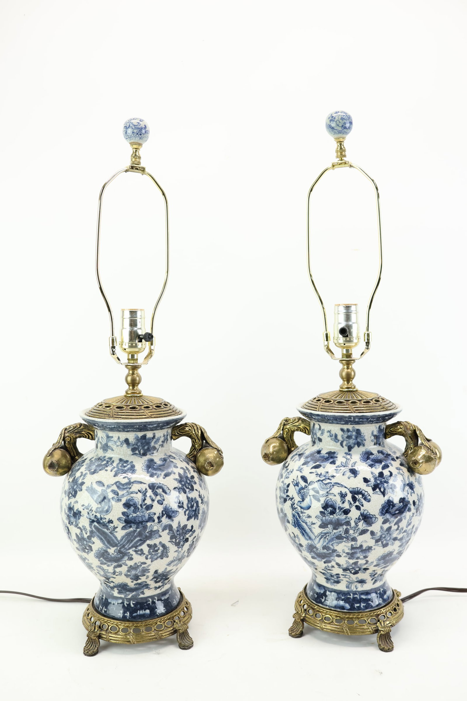 Pair of Chinese Blue and White Porcelain Table Lamps: Pair of Chinese Blue and White Porcelain Table Lamps Pair of Chinese Blue and White Porcelain Table Lamps. With gilt metal mounted base and handles. Used condition, wear, worn, unknown working conditi