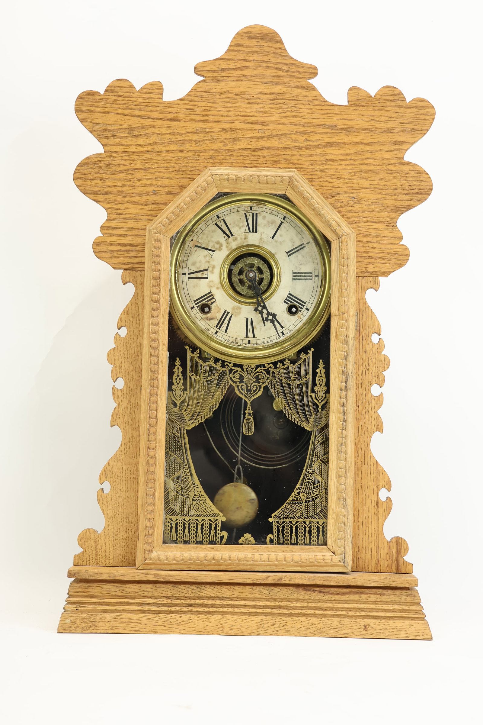 Antique Gilbert Gingerbread Clock: Antique Gilbert Gingerbread Clock Antique Gilbert Gingerbread Clock, in oak case, having paper label on verso, "Navy No. 25"; Used unknown working condition; 21 3/4"h x 13"w x 4"d