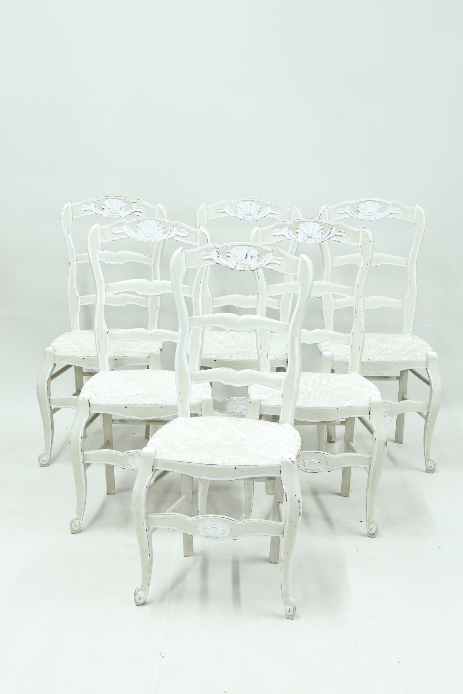 Set of Six French Country Dining Chairs: Set of Six French Country Dining Chairs Set of Six French Country Dining Chairs each painted in white with carved shell form backrest. Used condition, wear, worn, losses. Measures 38" tall x 17 1/2" w