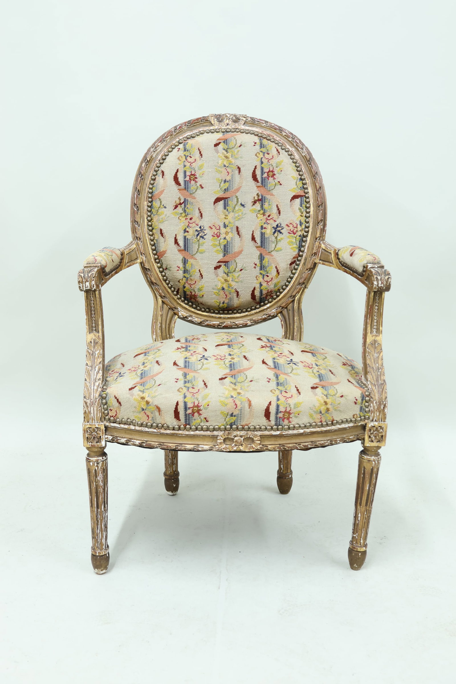 Louis XVI Style Fauteuil: Louis XVI Style Fauteuil Louis XVI Style Fauteuil having floral decorated needlework upholstery. Used condition, wear, worn, losses. 35 1/2" tall x 24" wide x 20" deep x 18" tall to top of seat