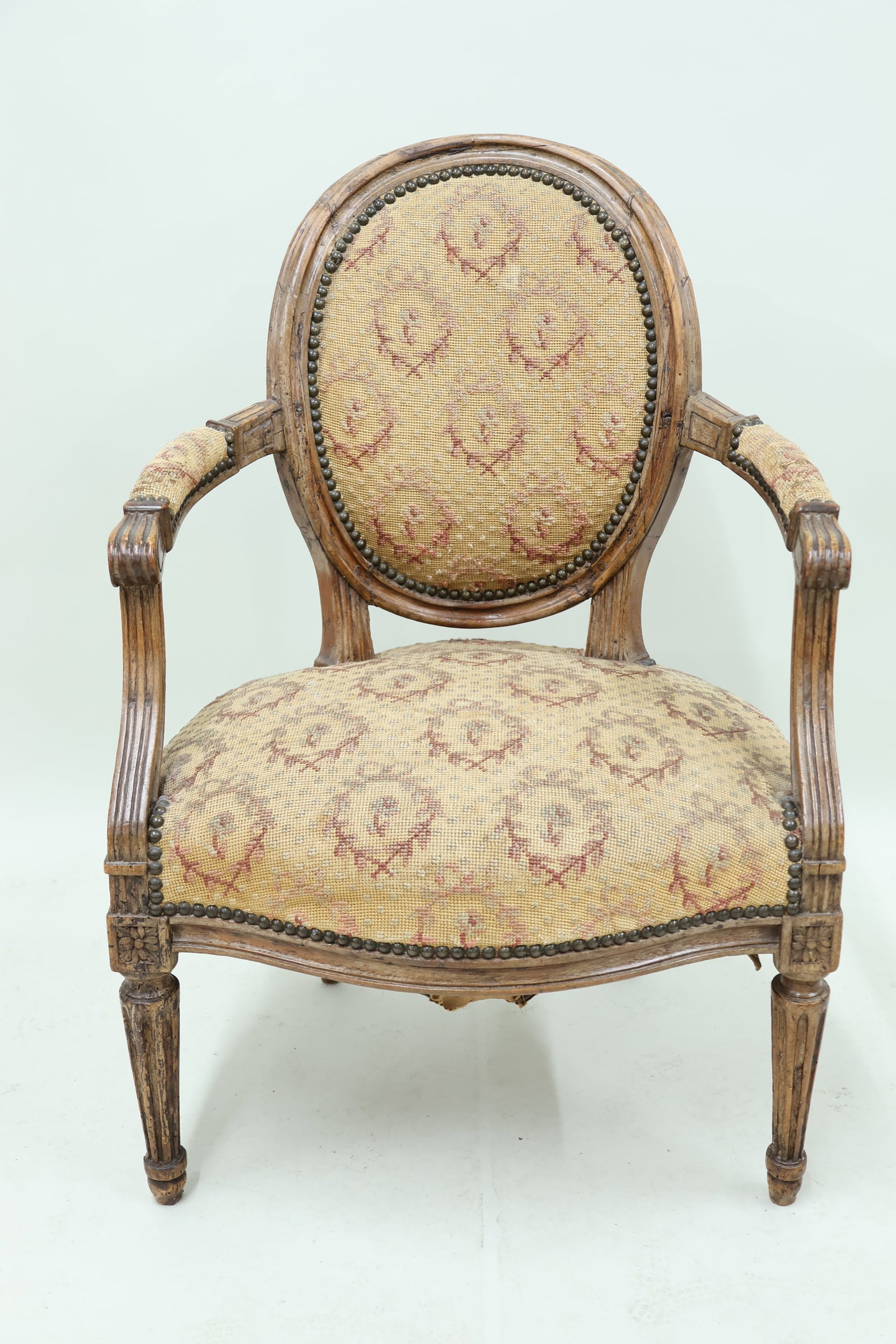Antique Louis XVI Style Fauteuil: Antique Louis XVI Style Fauteuil Antique Louis XVI Style Fauteuil having floral decorated needlework upholstery. Used condition, wear, worn, losses, repairs. 34 1/2" tall x 23" wide x 20 1/2" deep x