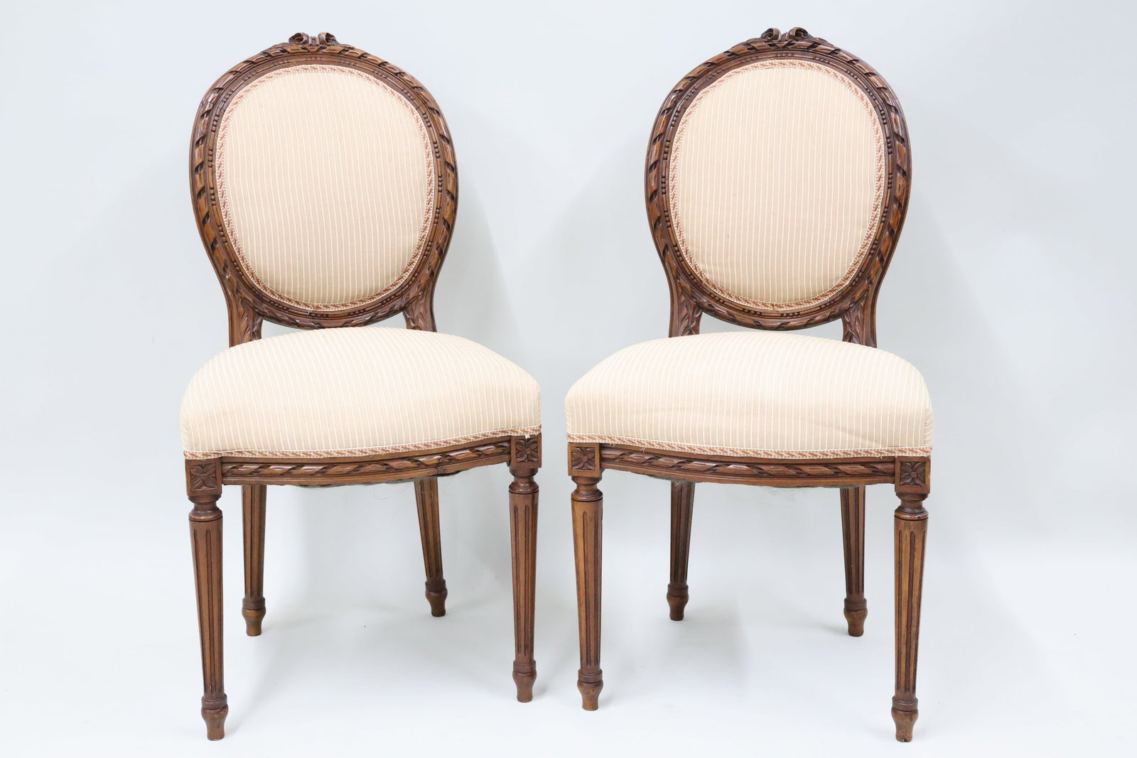 Pair of Louis XVI Style Side Chairs: Pair of Louis XVI Style Side Chairs Pair of Louis XVI Style Side Chairs each having a carved floral crest above balloon shaped backrest. Used condition, wear, worn, losses. 36 1/4" tall x 19" wide x