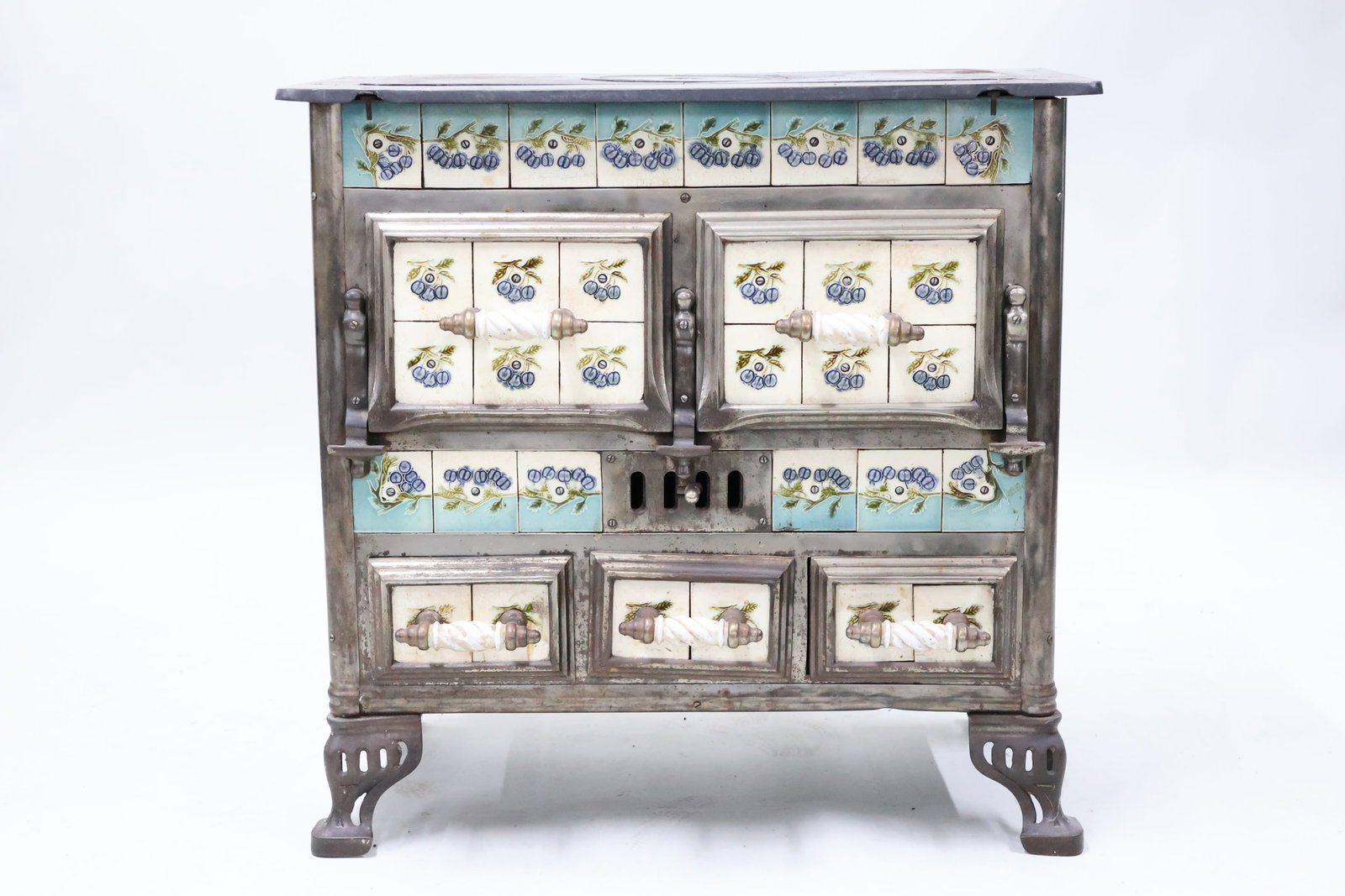 Antique French Majolica Tile Work Cast Iron Cooking Stove: Antique French Majolica Tile Work Cast Iron Cooking Stove Antique French Majolica Tile Work Cast Iron Cooking Stove featuring myrtille decorated tiles with porcelain handles. Used condition, wear, wor