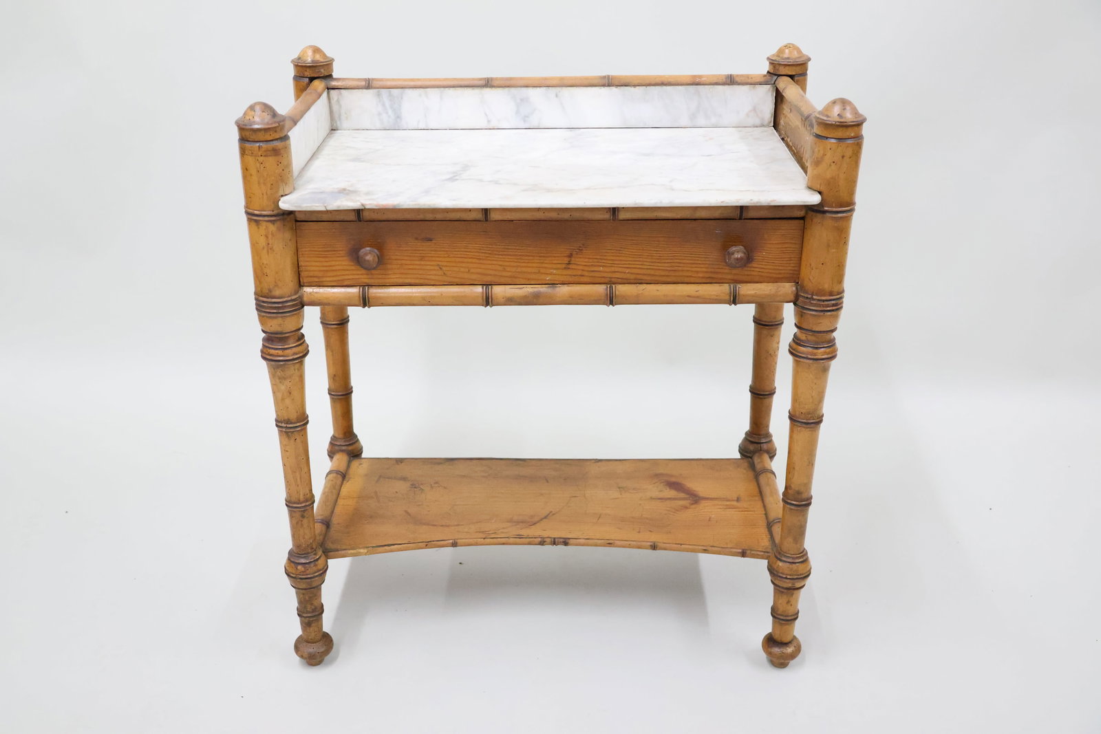 Victorian Bamboo Style Washstand: Victorian Bamboo Style Washstand Victorian Bamboo Style Washstand. Having a single drawer above an open shelf. Used condition, wear, worn, losses. Missing marble. Measures 34" tall x 17" x 30".