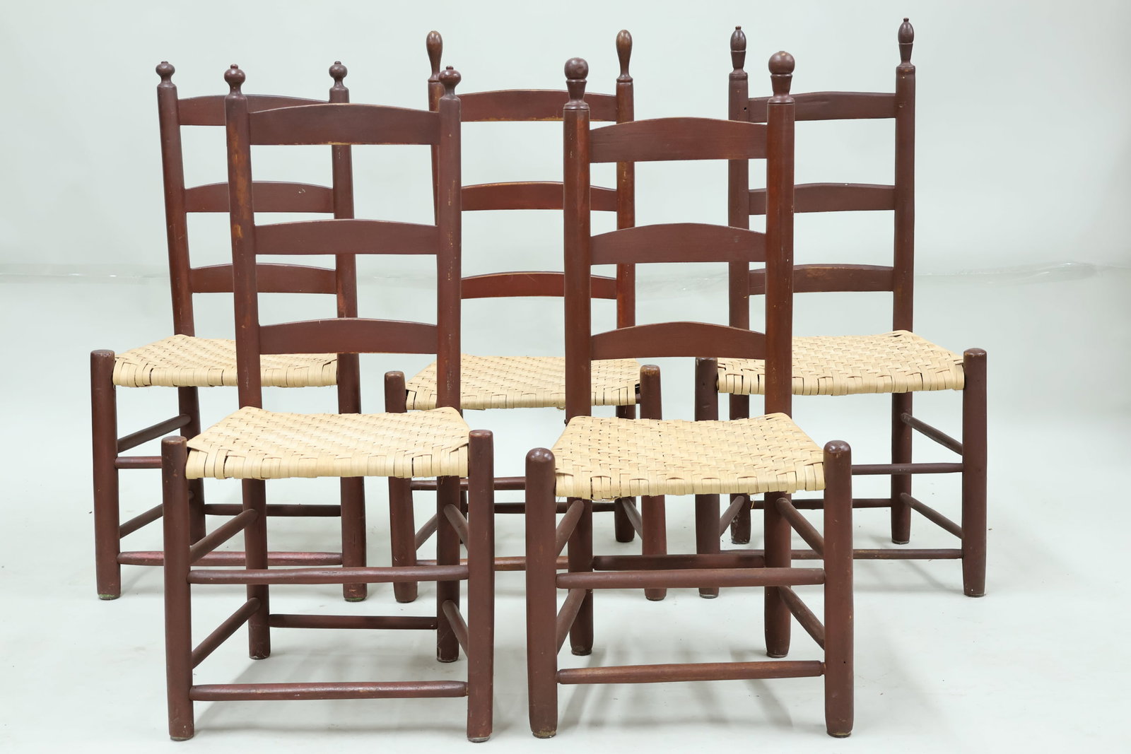 Five Assorted Red Painted Ladderback Primitive Side Chairs: Five Assorted Red Painted Ladderback Primitive Side Chairs Antique Group of Five Assorted 19 C. Red Painted Ladderback Primitive Side Chairs, New England each having a flat reed splint seats.