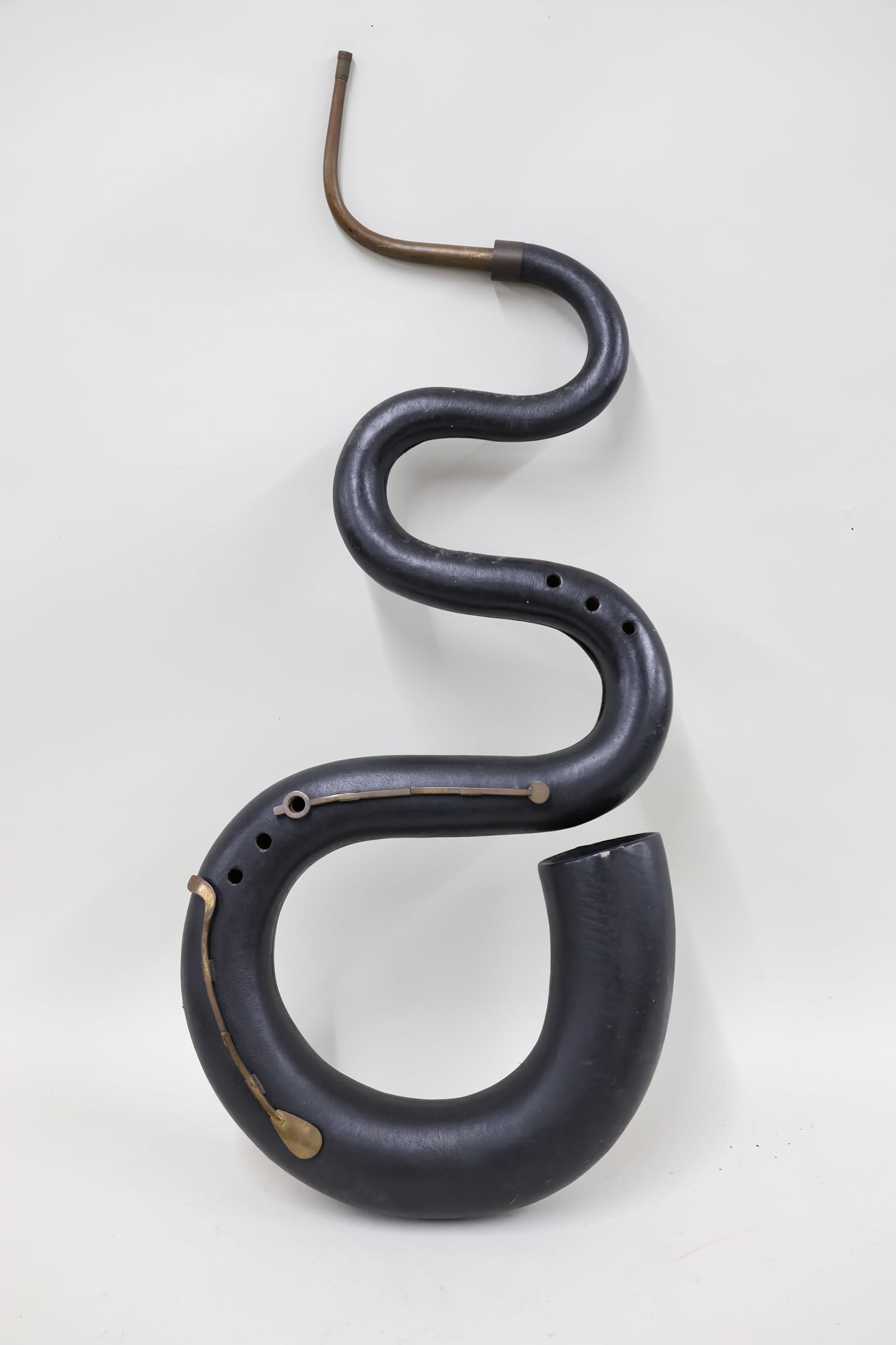 Vintage Leather Wrapped Serpent Wind Instrument: Vintage Leather Wrapped Serpent Wind Instrument Vintage Leather Wrapped Serpent Wind Instrument. Used condition, surface distress. 41" x 17" x 4 1/2"