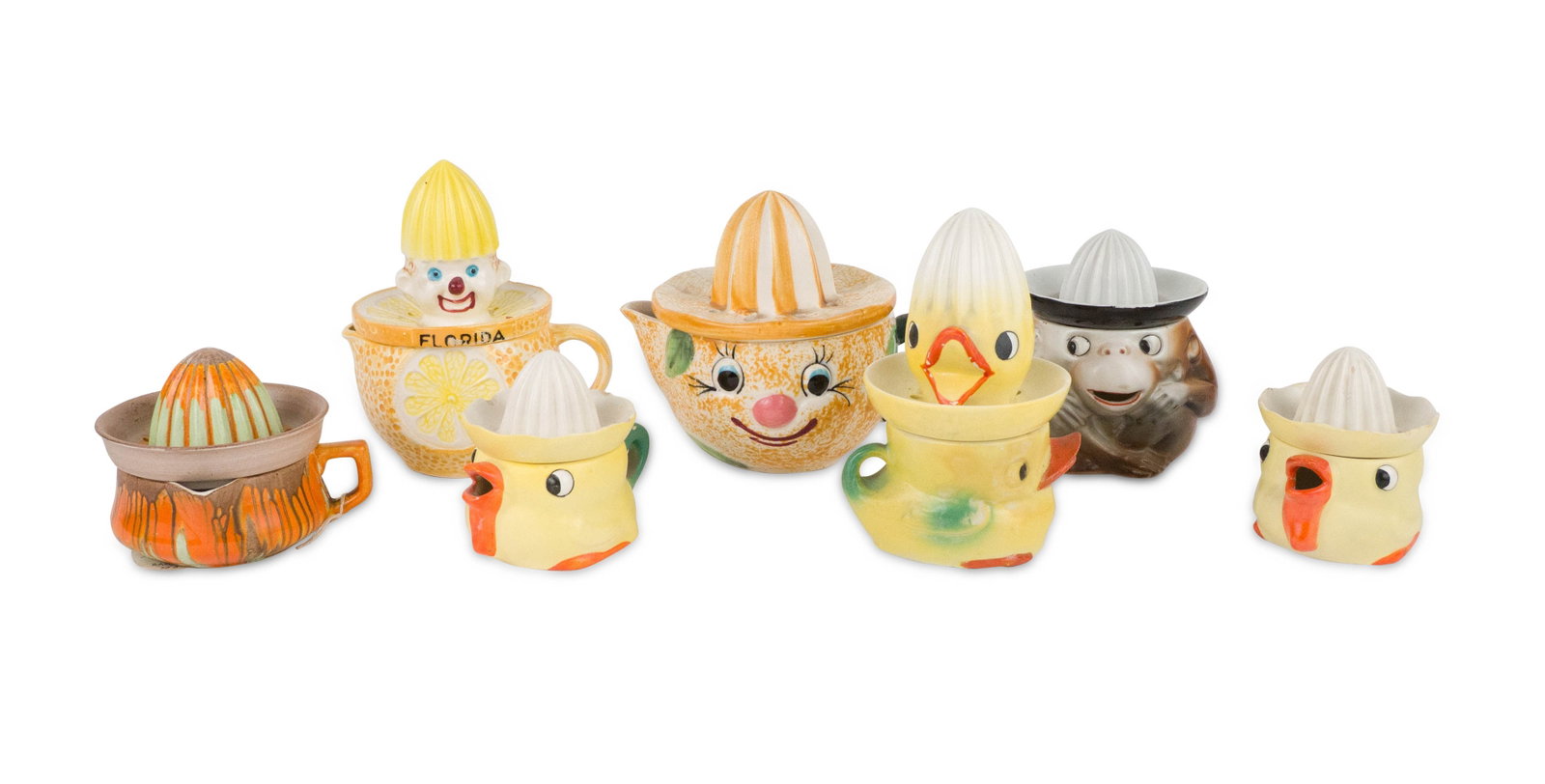 Seven Porcelain Figural Juicers: Seven Porcelain Figural Juicers Including, a clown, ducks, orange, and a monkey. Largest: 5 1/2 x 6 x 4 1/2 in. (14 x 15.2 x 11.4 cm.)