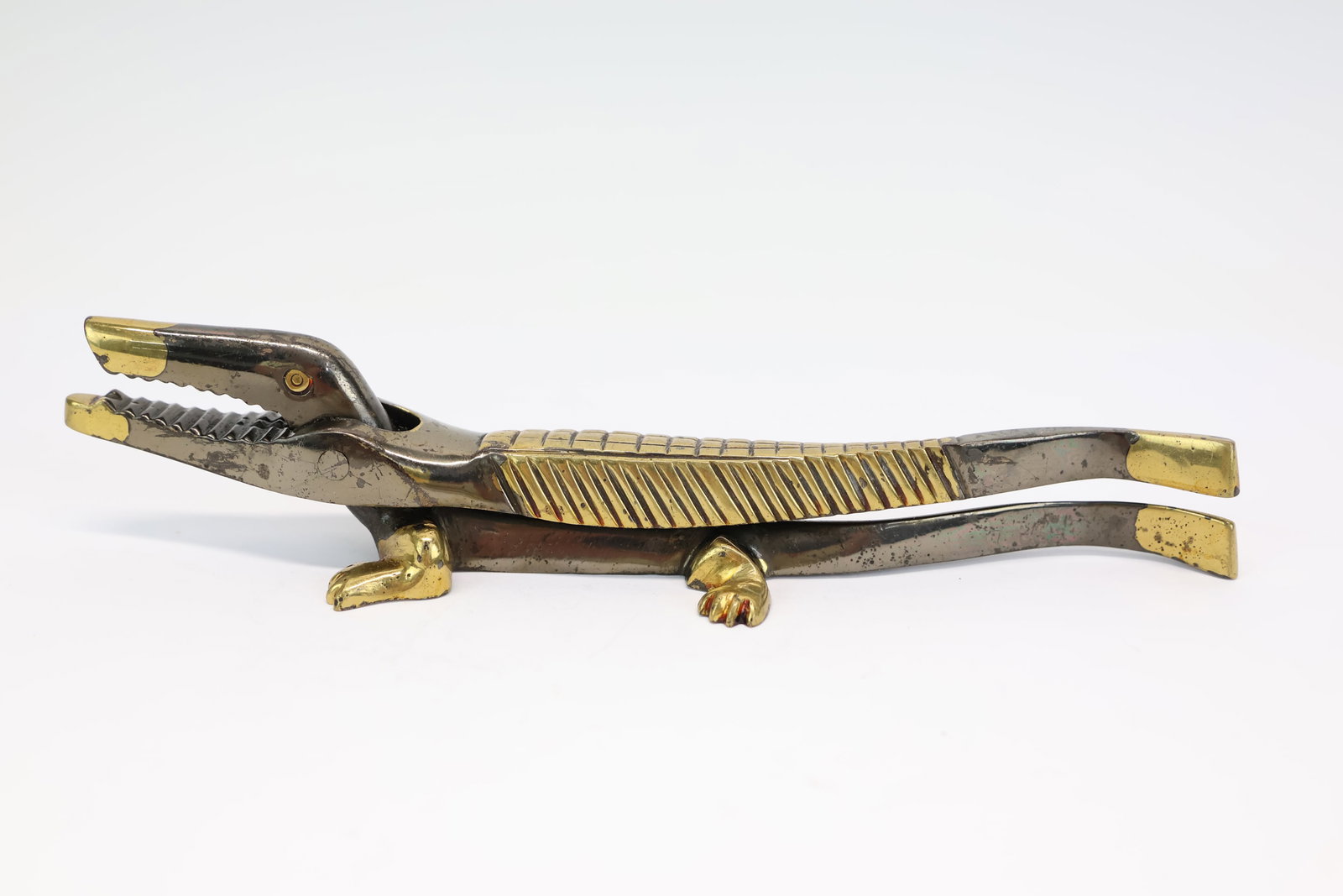 Crocodile Form Brass Nutcracker: Crocodile Form Brass Nutcracker Crocodile Form Brass Nutcracker with gilt accents; used condition, wear/worn, surface distress, scratches; measures approximately 7" x 1 1/4" x 1 1/2"