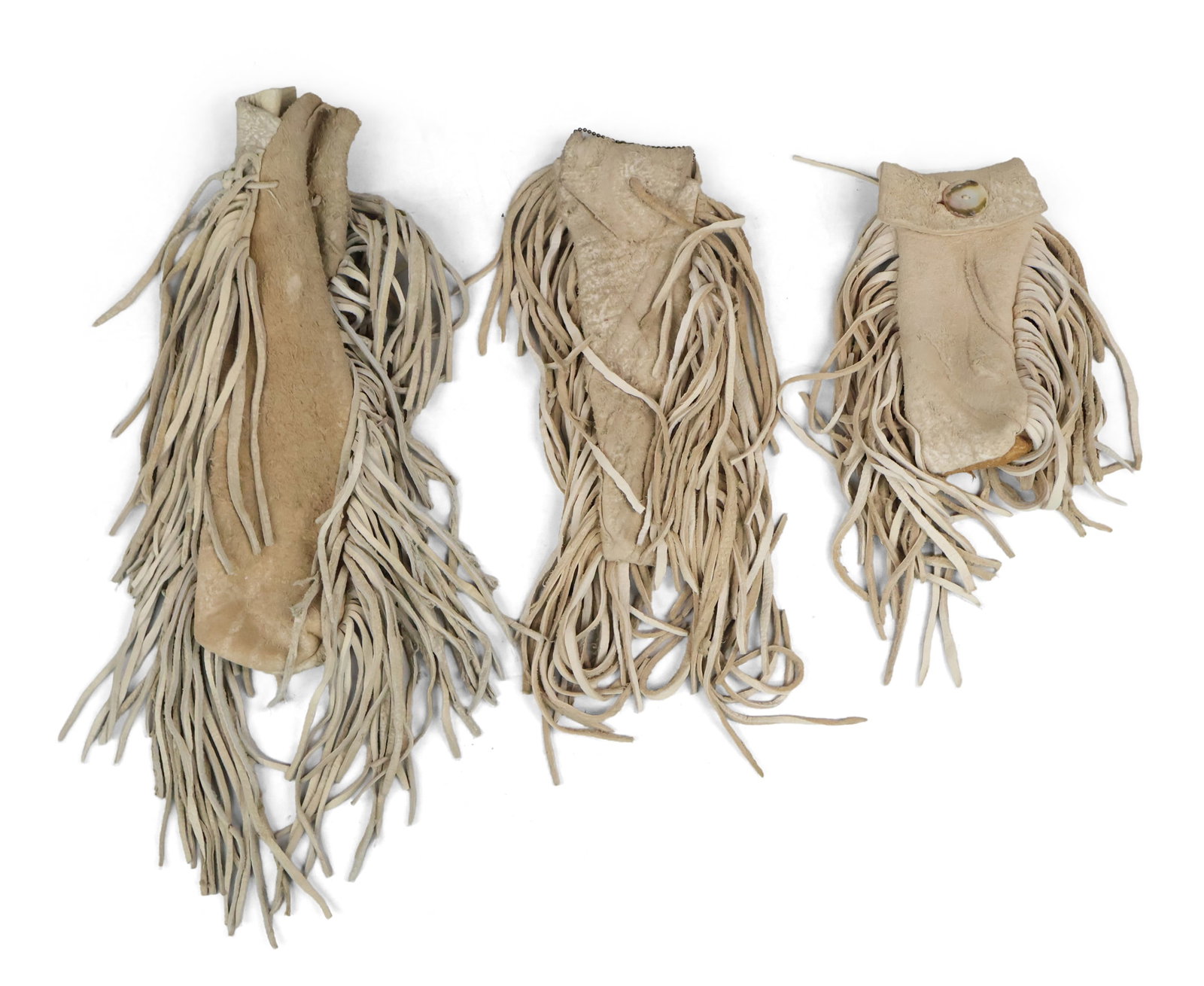 Three Fringed Leather Bags: Three Fringed Leather Bags Including, Pipe/Tobacco bags. Largest: 19 1/2 x 6 in. (49.5 x 15.2 cm.)