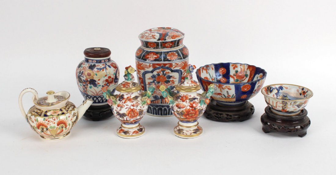 Seven Imari-Style Table Articles: Japanese. Comprising, a miniature teapot, two small bowls, two covered ginger jars, and two floral-decorated urns. Largest: 6-1/4"h x 4"w