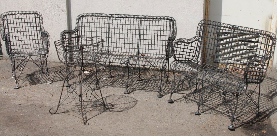 Black-Painted Wrought-Iron Garden Furniture: Comprising, two settees, a chair, and a planter. Settee: 35"h x 4`11"w x 21"d