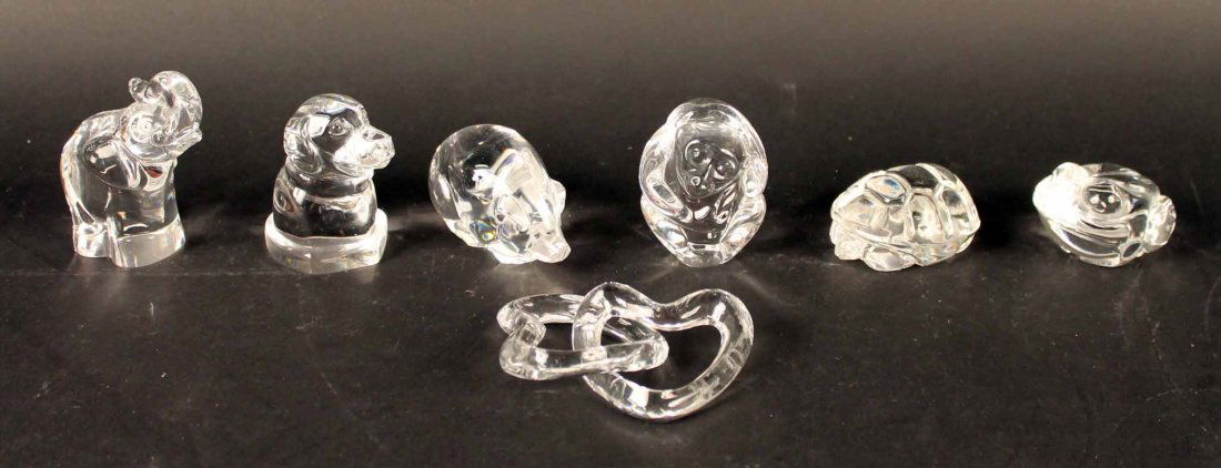 Six Steuben Glass Animal Figures: Comprising a frog, monkey, turtle, pig, dog and elephant. Together with a Baccarat glass crossed hearts. 2 3/4"h