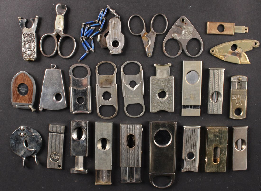 Twenty-Five Silver Metal Cigar Cutters: Some marked with maker's marks, one sterling. Largest: 3"l