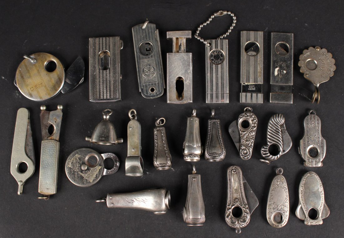Twenty-Five Silver Metal Cigar Cutters: Some marked with maker's marks, six sterling cased. Largest: 2-3/4"l