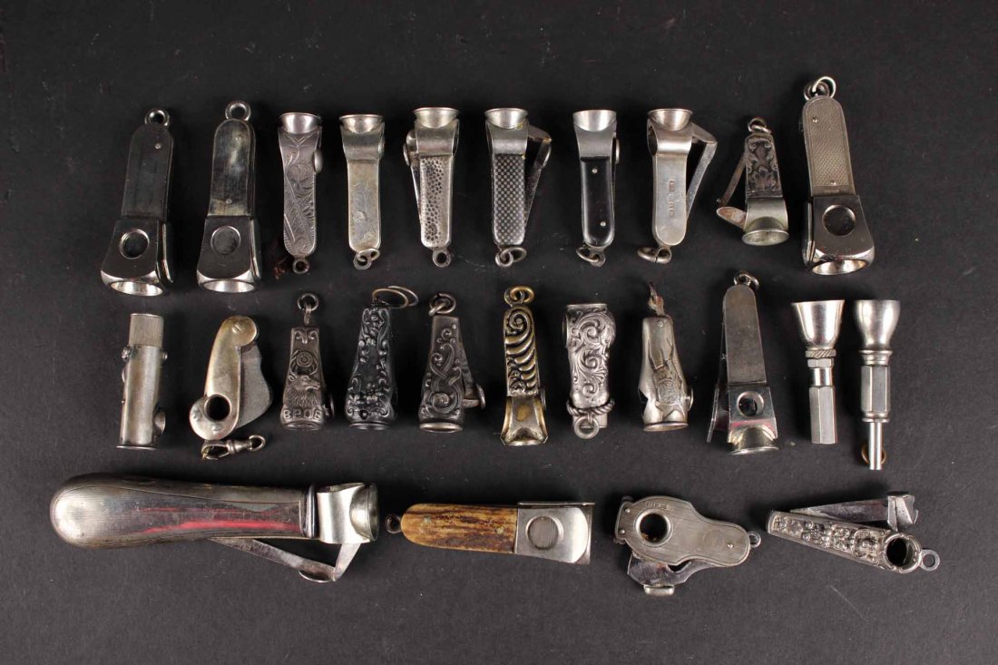 Twenty-Five Silver Metal Cigar Cutters: Some marked with maker's marks, eleven sterling cased or handled. Largest: 4"l