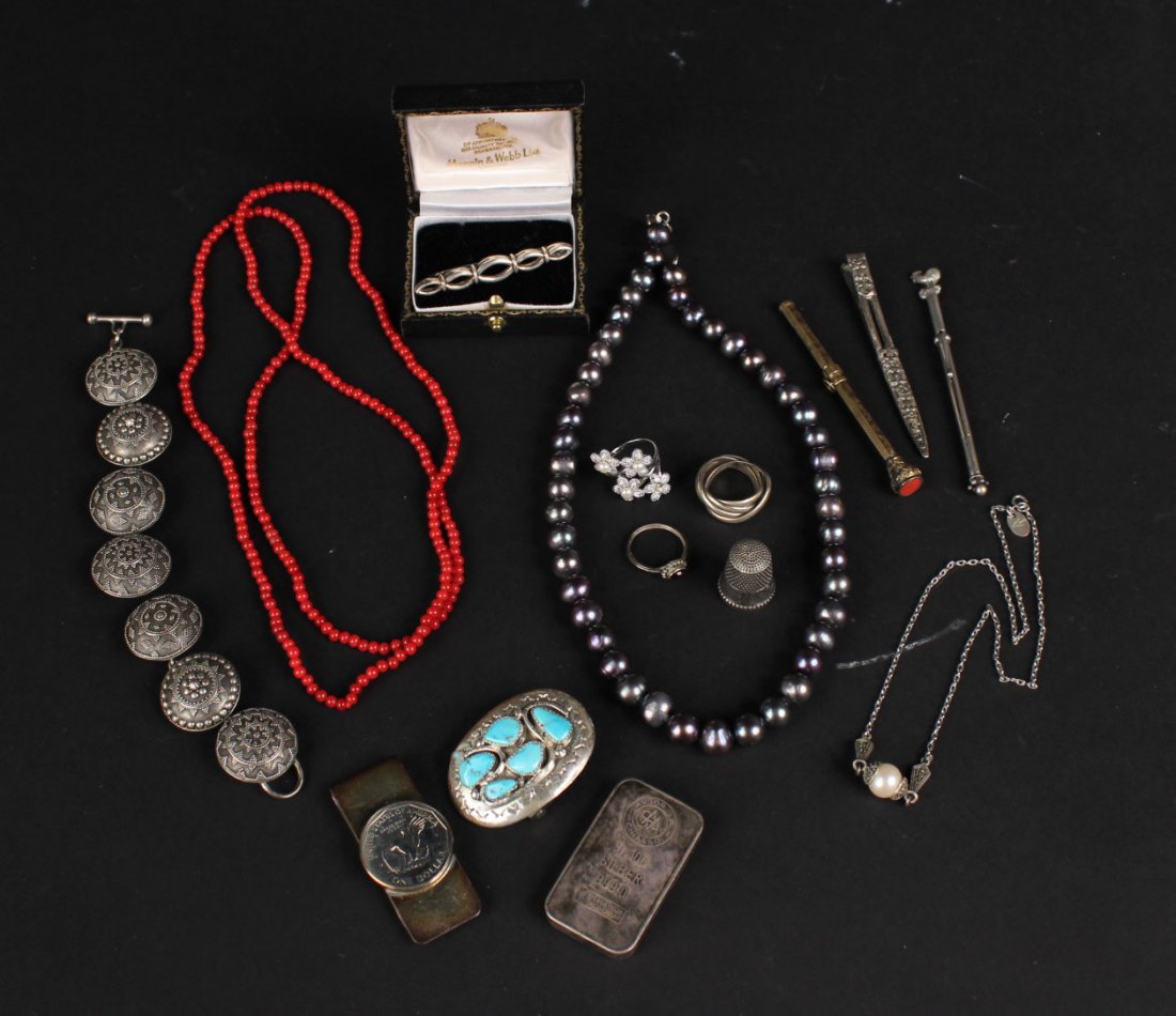 Group of Silver Jewelry Items: Including an Arts & Crafts bar pin, a belt buckle set with turquoise stones, a Tiffany money clip set with a US silver dollar, champagne bubble wand, an Indonesian puffed circular link bracelet, pearl