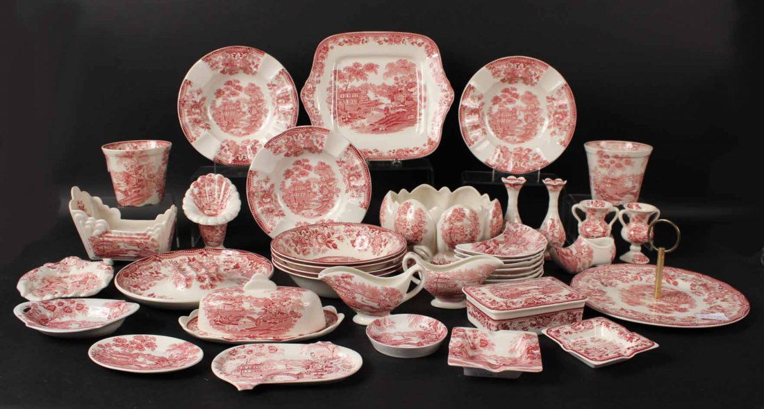 Group of Red & White Clarice Cliff Table Articles: Comprising: 2 urns, 3 vases, 2 platters, 2 gravy boats, hand-form dish, lobed planter, tazza, covered box, covered butter, cradle-form dish, Dutch shoe, 3 ash trays, dish, four bowls, seven bone dishe