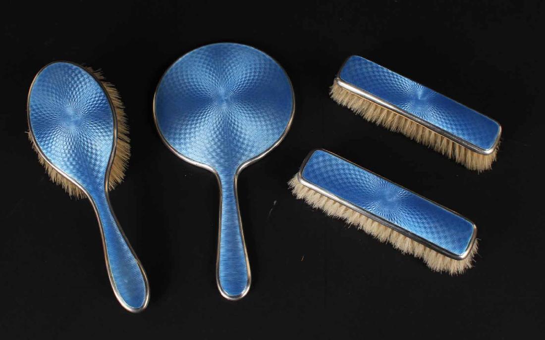 Sterling and Blue Enamel Dresser Set: Comprising two clothes brushes, a hairbrush and a hand mirror. 9.5"l