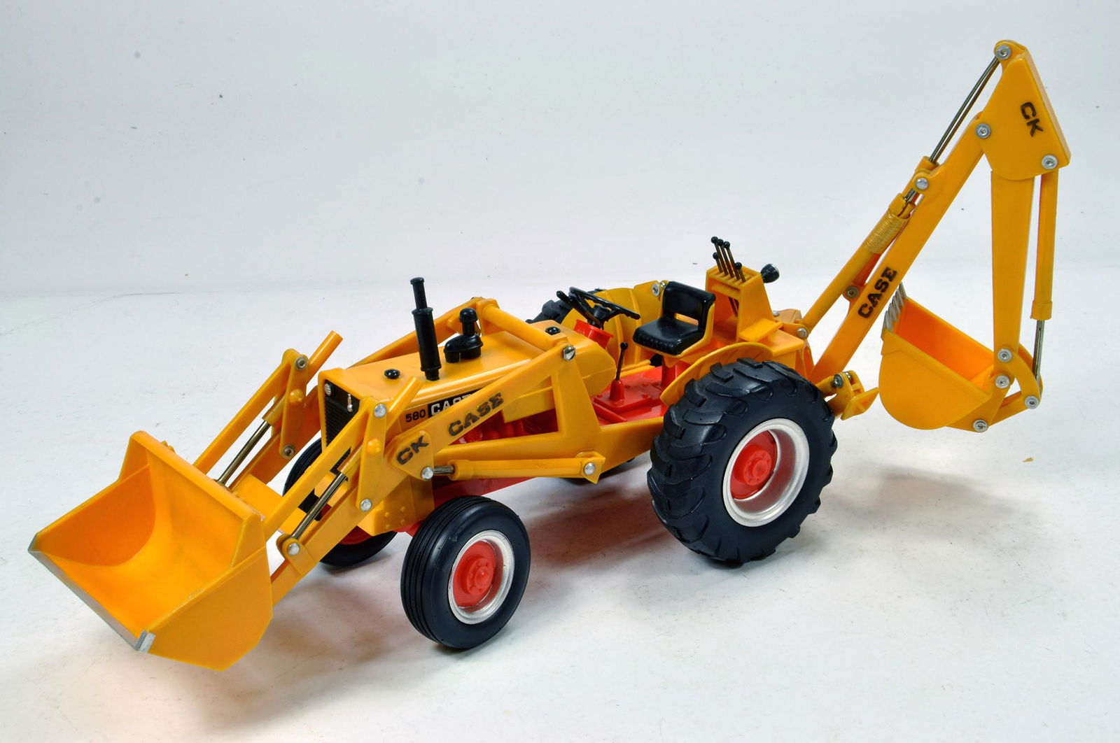 An extremely rare 1/16 plastic issue model of the Case: An extremely rare 1/16 plastic issue model of the Case CK Construction King 580 Backhoe Loader Tractor. This Empire made (Hong Konh) piece is superb and displays well.