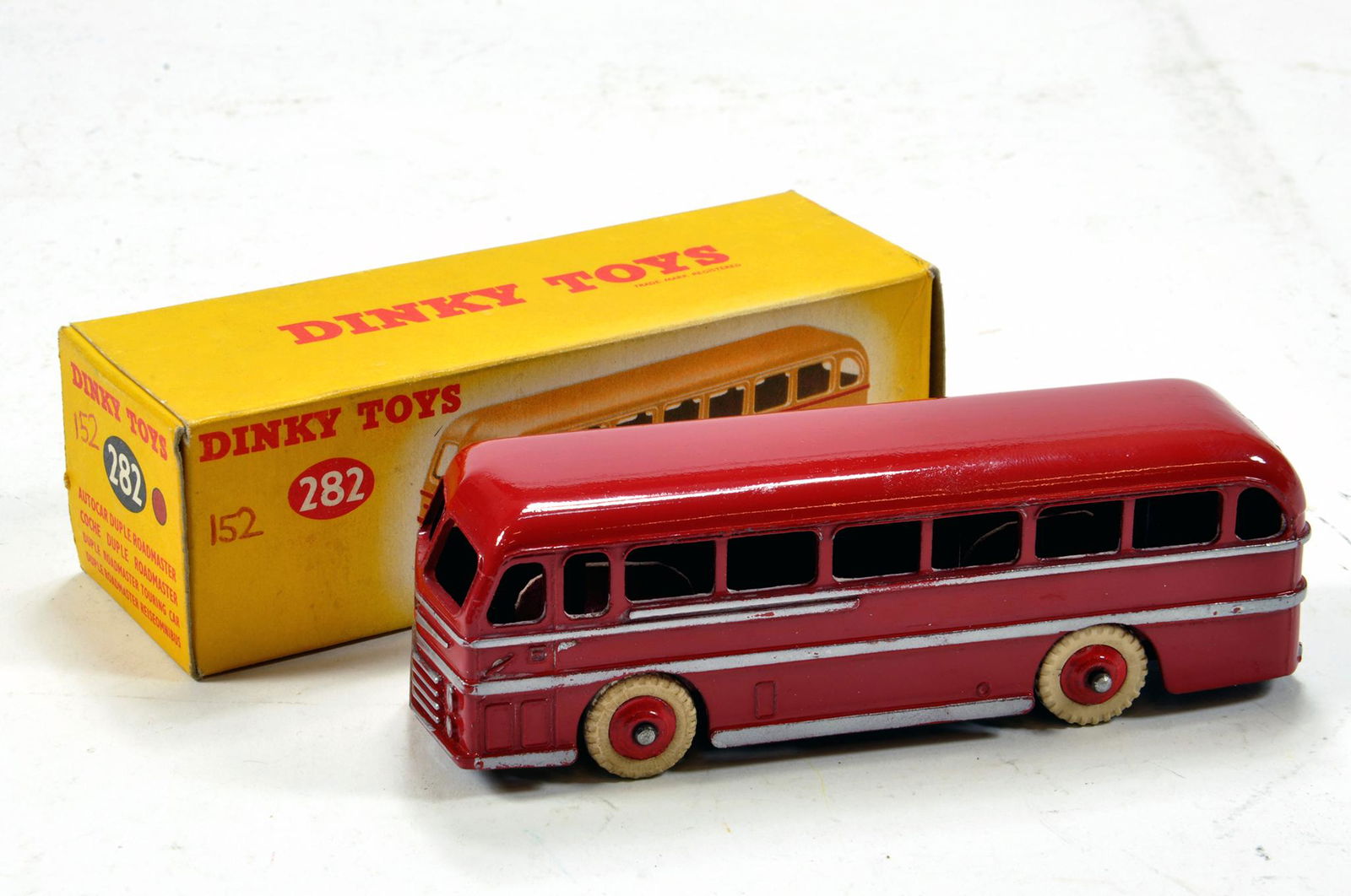 Dinky No. 282 Duple Roadmaster Coach in red with white: Dinky No. 282 Duple Roadmaster Coach in red with white treaded tyres. Generally E in VG Box.