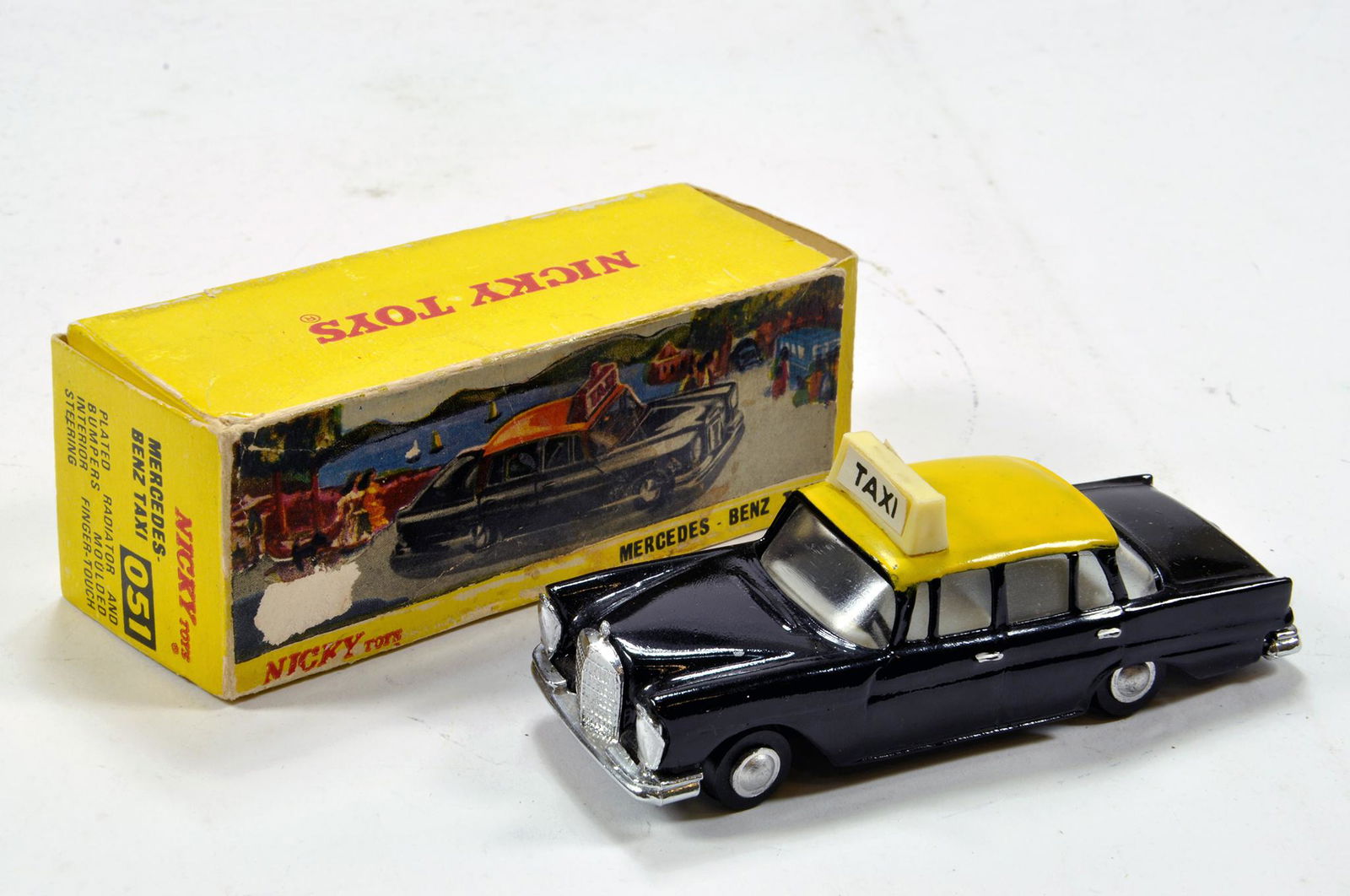 Dinky (Nicky Toys) No. 051 Mercedes Taxi in black with: Dinky (Nicky Toys) No. 051 Mercedes Taxi in black with yellow roof, pale grey interior, chrome and silver trim. Generally E to NM in G Box.