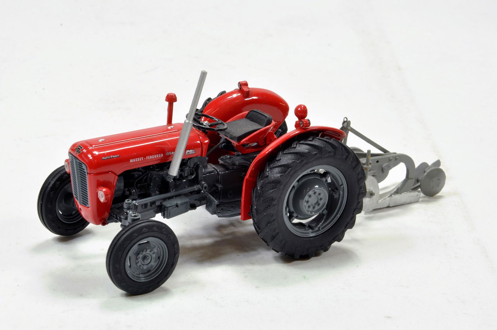 Universal hobbies 1/32 Massey Ferguson 35X tractor with: Universal hobbies 1/32 Massey Ferguson 35X tractor with scratch built plough. Generally excellent with box.