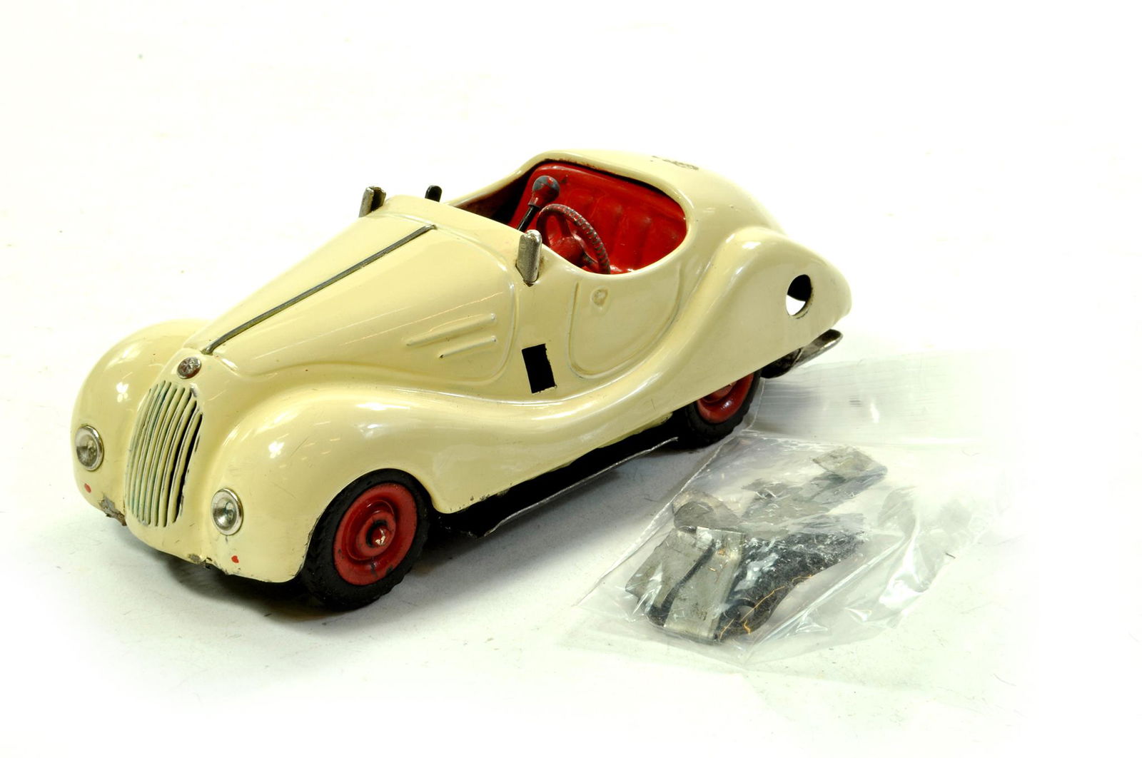 An original Schuco Mechanical Car in Pale White.: An original Schuco Mechanical Car in Pale White. Requires some re-assembly but maintains a bright look. Enhanced Condition Reports: We are more than happy to provide further images of any lot. Please