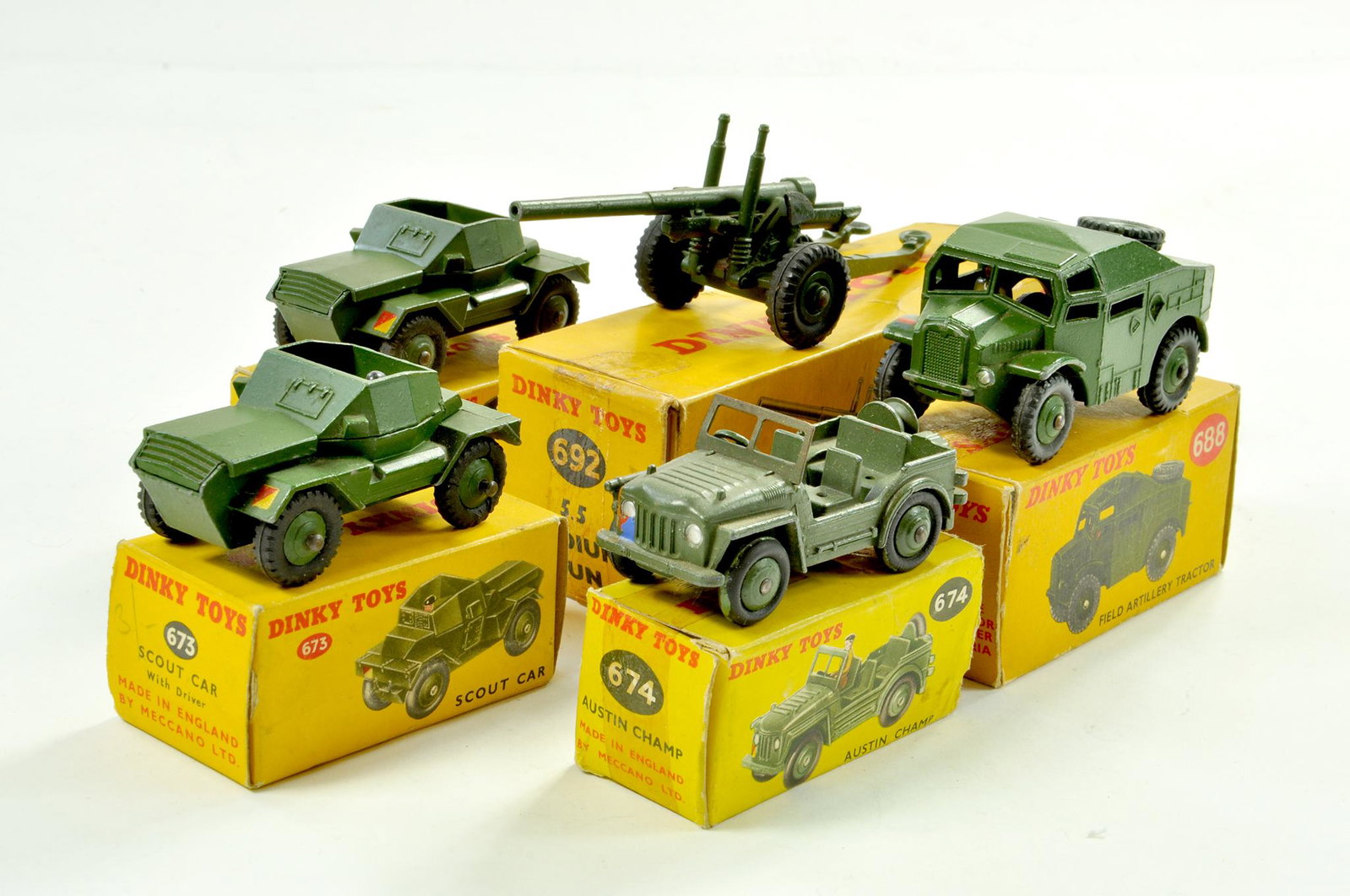 Dinky Group of Military Vehicles comprising Scout Car,: Dinky Group of Military Vehicles comprising Scout Car, Austin Champ, Artillery Tractor, Medium Gun and Scout Car. All generally very good to excellent in fair to good boxes. Note: We are always happy 