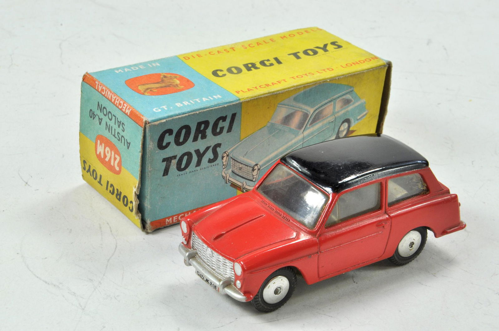 Corgi No. 216M Austin A40 with flywheel motor (works: Corgi No. 216M Austin A40 with flywheel motor (works well). Red body with black roof. Grey base and flat spun hubs. Appears excellent with only the odd minor mark contained in generally good original
