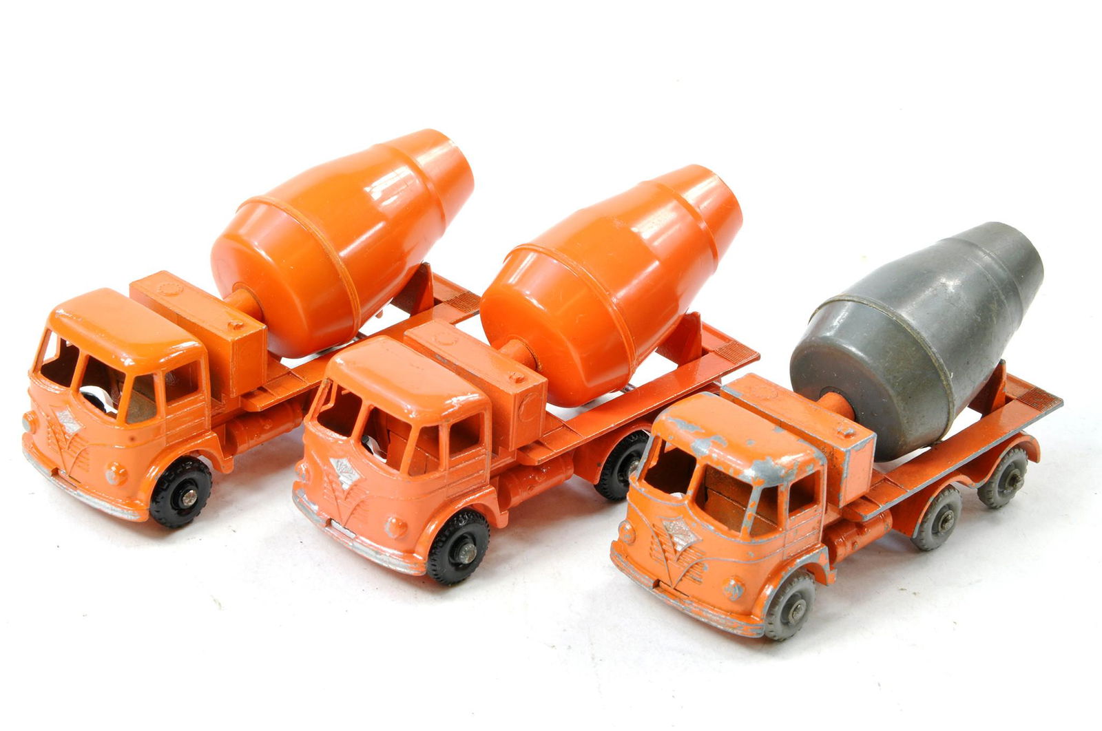 Trio of variations of Matchbox Regular Wheels no. 26b Foden Cement Mixer including harder to find: Trio of variations of Matchbox Regular Wheels no. 26b Foden Cement Mixer including harder to find grey barrel. Scarce issue is fair with notable wear with the other two generally very good with only m