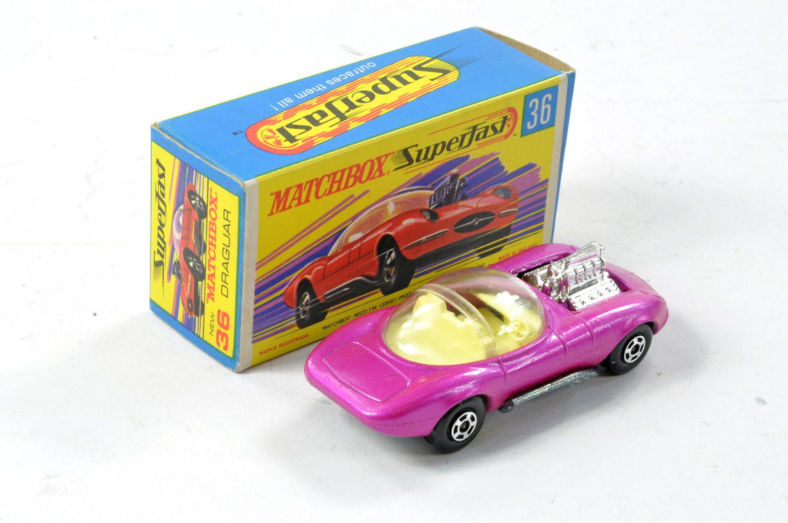 Matchbox Superfast No. 36b Draguar. Metallic Pink with clear windows, unpainted base. Generally: Matchbox Superfast No. 36b Draguar. Metallic Pink with clear windows, unpainted base. Generally excellent the odd factory paint flaw in excellent G Type box, with new.