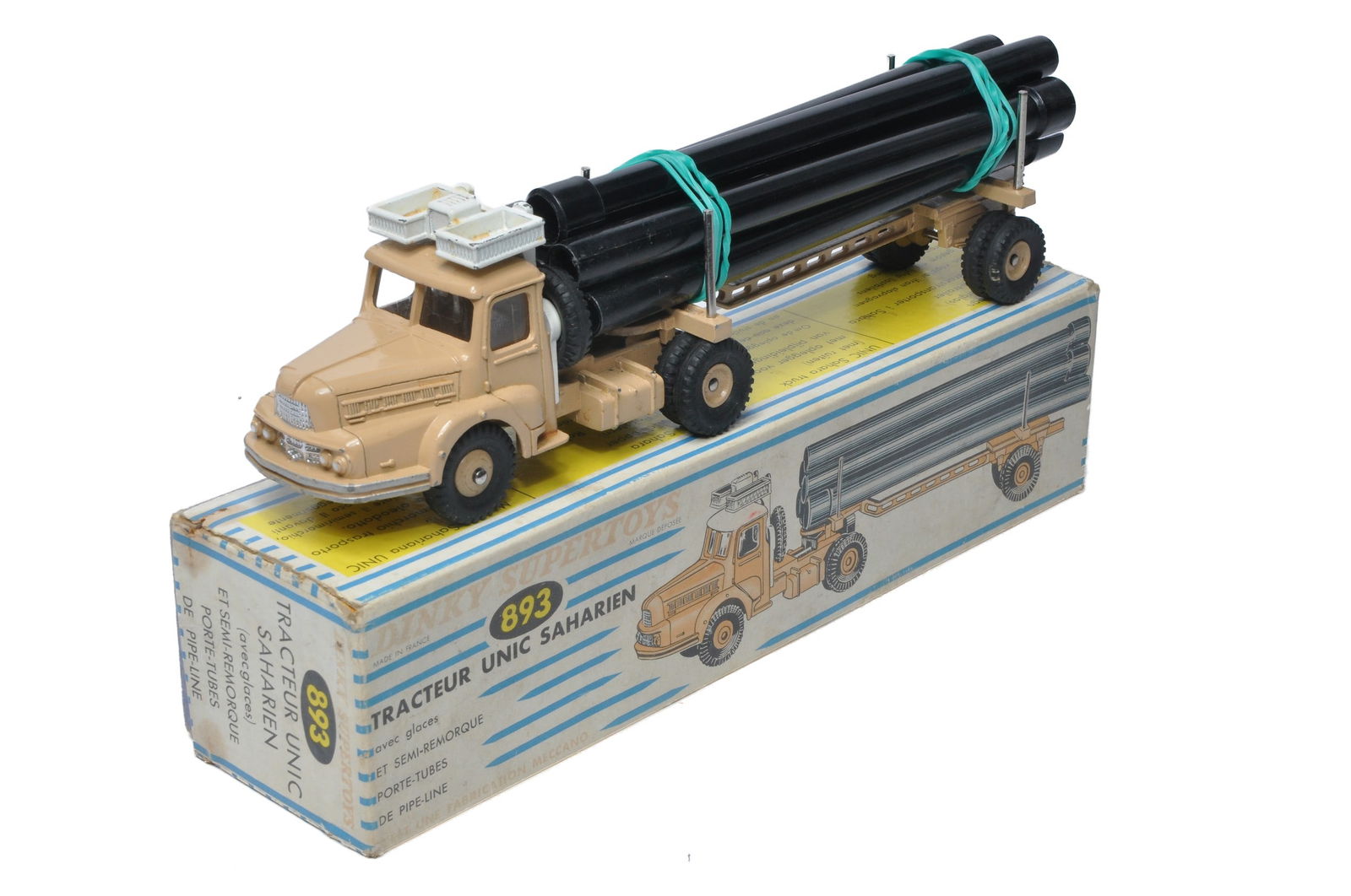 French Dinky No. 893 Unic Sahara Tractor with Pipe Trailer and Load. Displays good with some more: French Dinky No. 893 Unic Sahara Tractor with Pipe Trailer and Load. Displays good with some more notable marks. In good box, fading and wear in places.