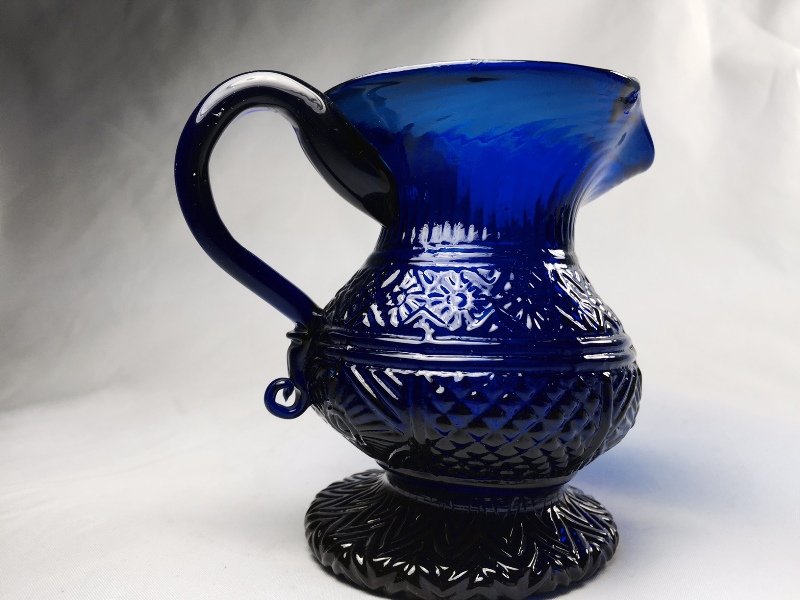 SANDWICH BLOWN THREE-MOLD BLUE CREAMER: 4 1/2"h.,Mck,G-III-26,cobalt blue,lead glass, ovoid body, applied handle, drawn foot, concentric rings on base, pontil scar; probably Sandwich Glass Works, Sandwich, Mass., c. 1820-30,unfortuanely it 