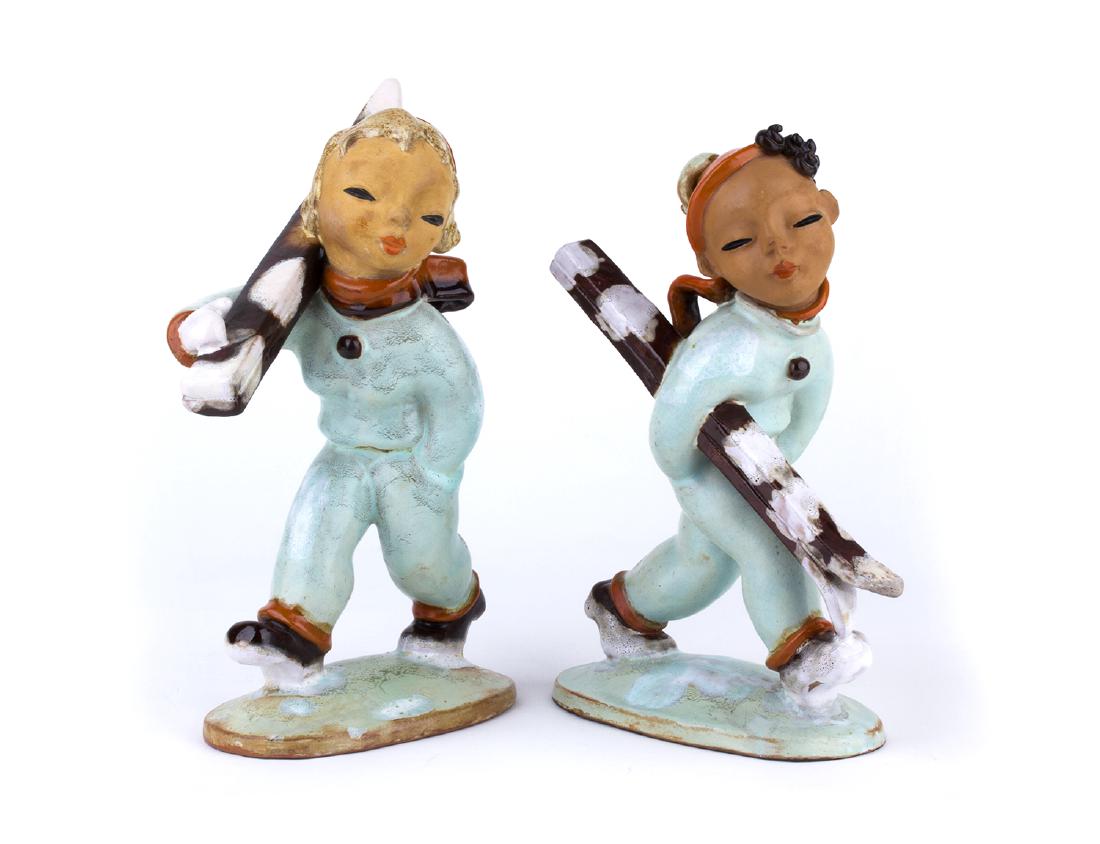 GOLDSCHEIDER - VIENNA - Couple of skiers, from the: GOLDSCHEIDER - VIENNA Couple of skiers, from the â€˜30s Polichrome painted earthenware covered with majolica, h. 24 cm (each) Mark inscribed under the base of both: Goldscheider Wien Made in Austr